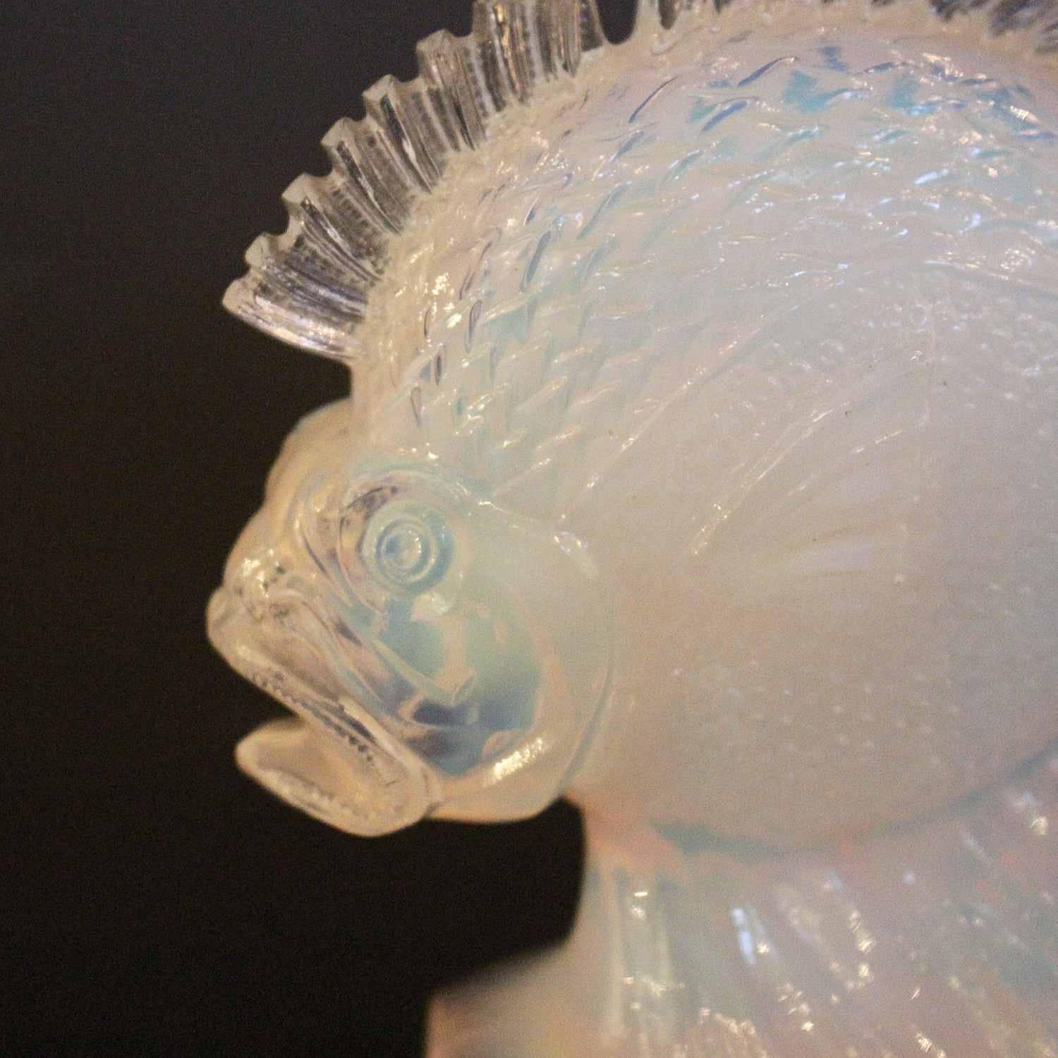 An opalescent, moulded glass paperweight in the form of a fish by Ferjac of France. 

