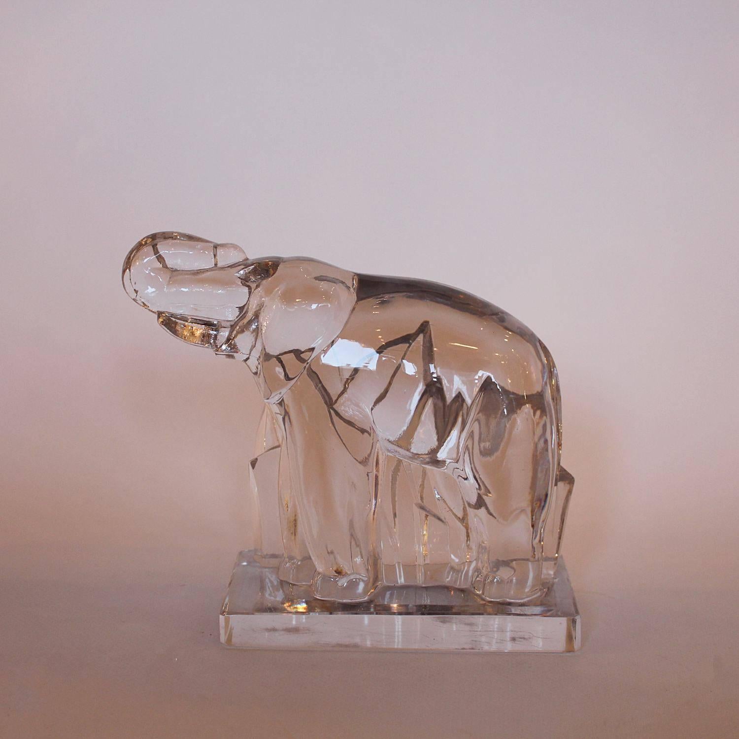 An Art Deco, crystal paperweight in the shape of a stylised elephant. Designed by Georges Chevalier for Baccarat. Set over an integral plinth with bevelled edges.
 