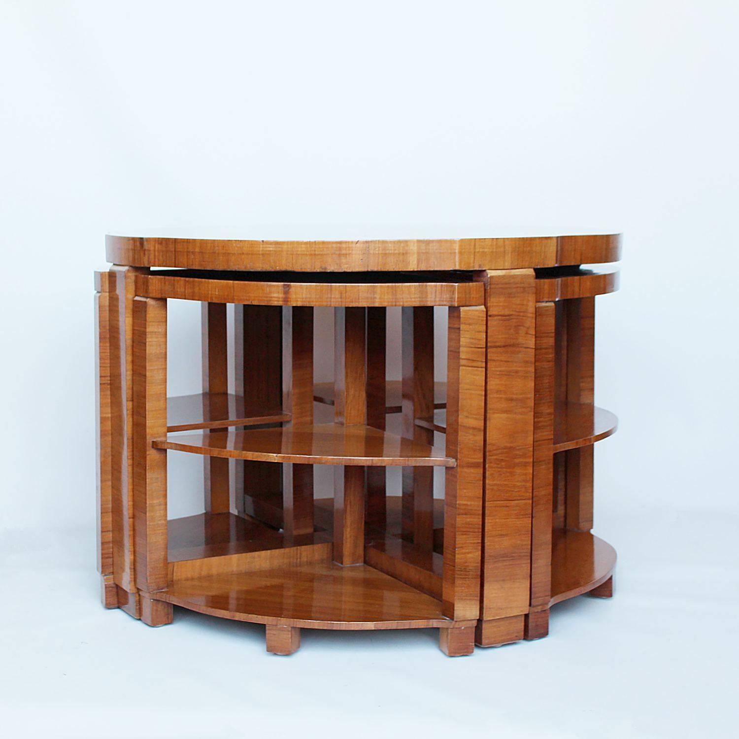 An Art Deco nest of tables. Circular table with cross footed base and four integral, shelved side tables. Burr walnut with straight grain walnut banding.

Dimensions: H 53 cm, D 76 cm, Side tables H 48 cm, W 47 cm, D 34 cm.



            