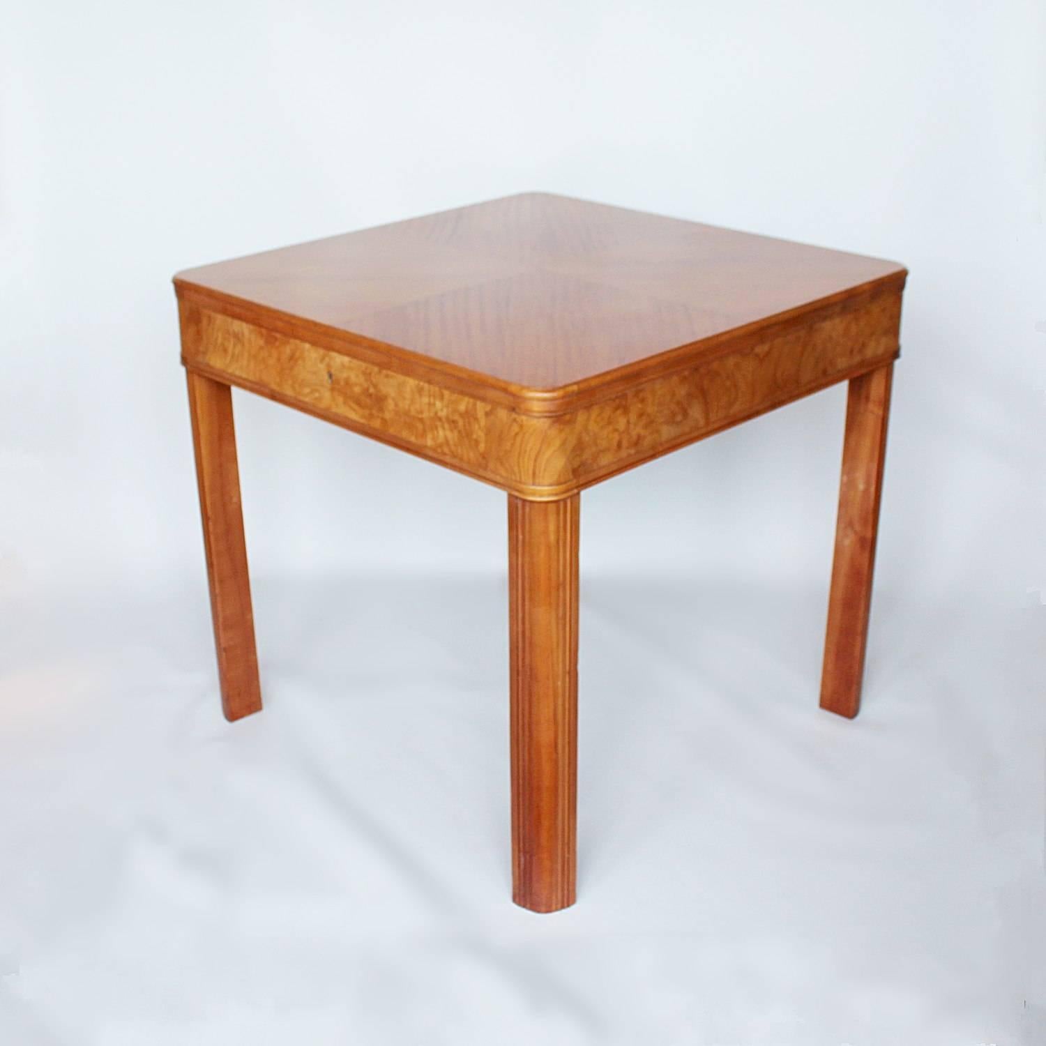 An Art Deco table with integral drawer. Satin birch with burr satin birch banding and carved legs.
 
    