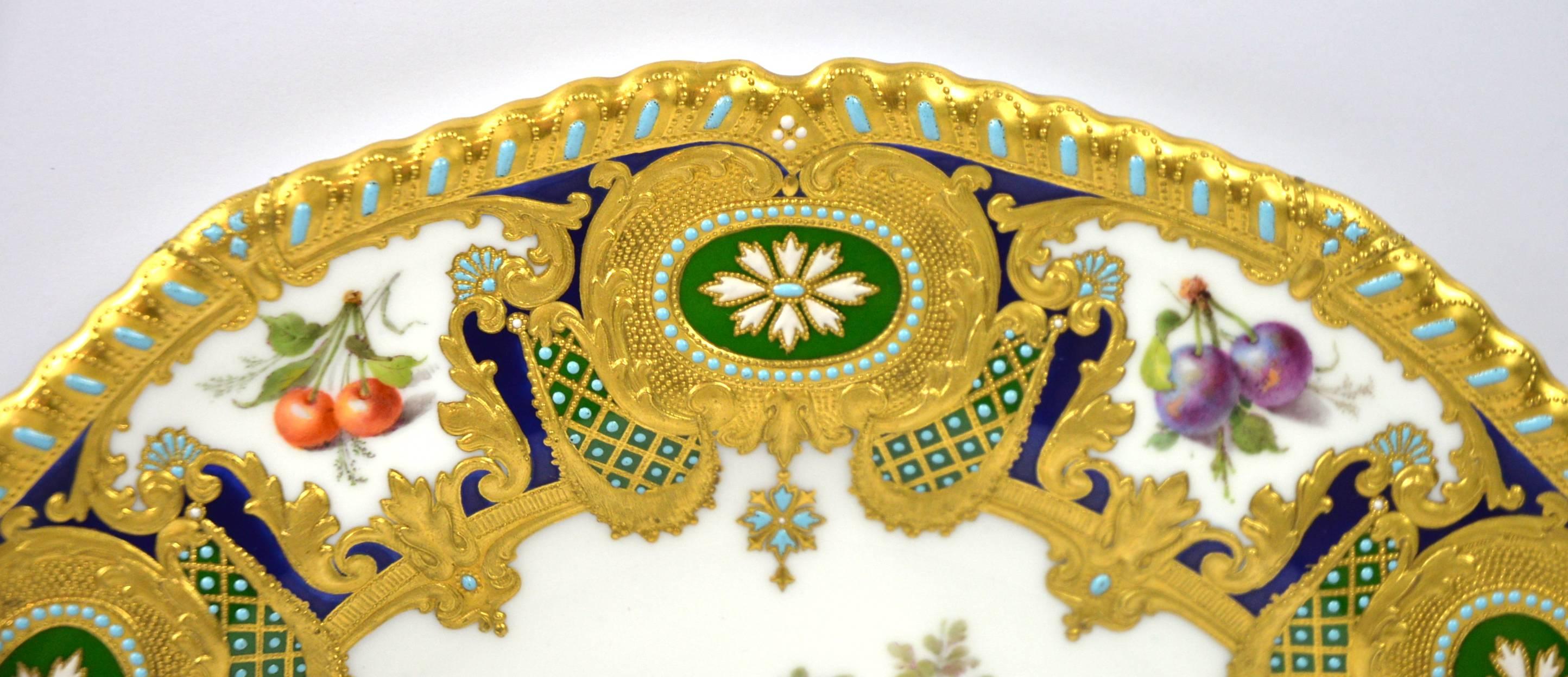 A rare and exceptional Royal Crown Derby cabinet plate, painted by Desire Leroy, dated 1906, of Royal gadroon shape with a richly decorated border, a cobalt blue ground, highlighted with gilding, turquoise and white jewelling, six cartouches painted