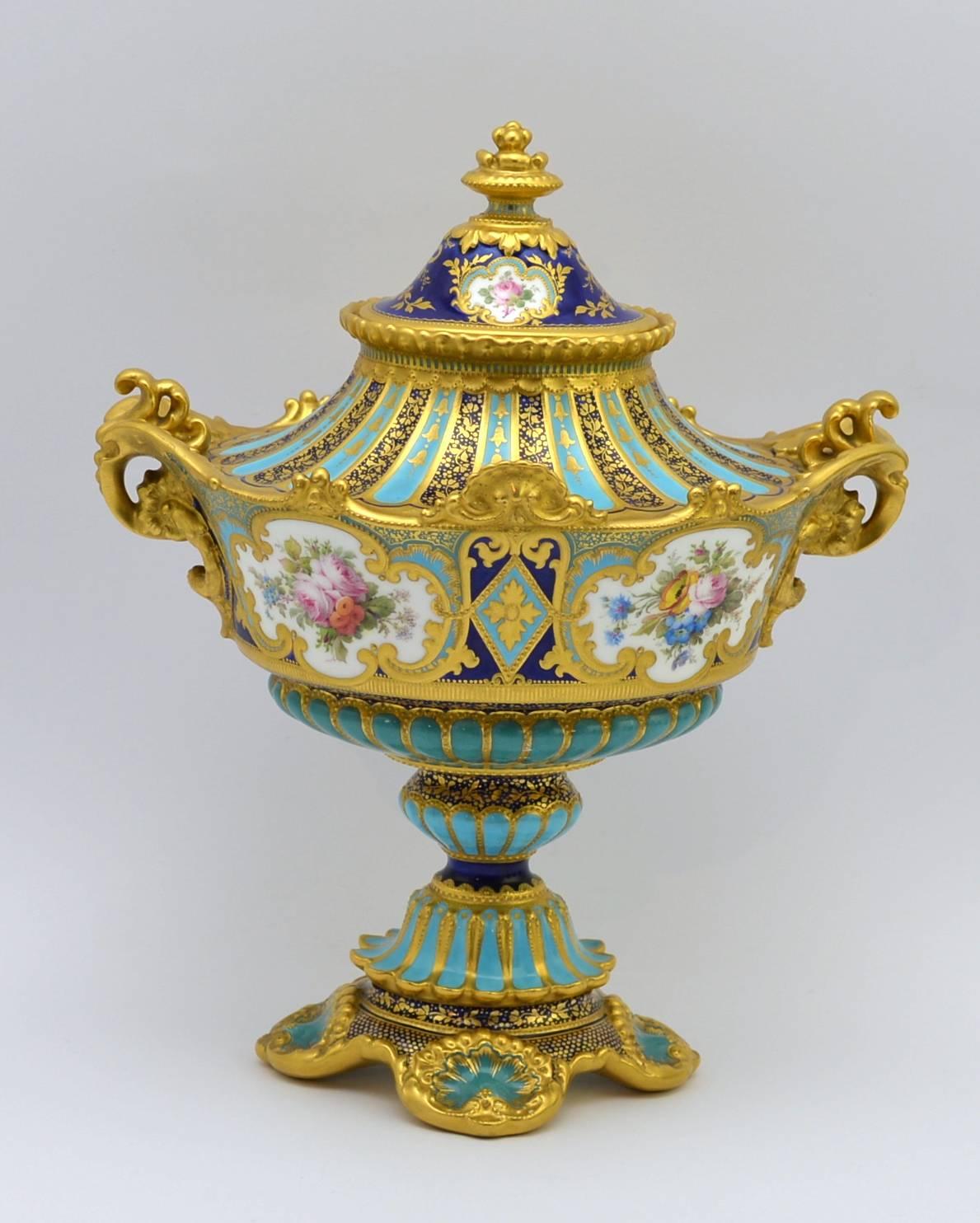 A fine and rare Royal Crown Derby vase, of unusually large size, the tapering oval body hand-painted with four quadrilobate reserves framed in raised and tooled gold, two painted with birds, one of which is signed 'Leroy', the remaining reserves