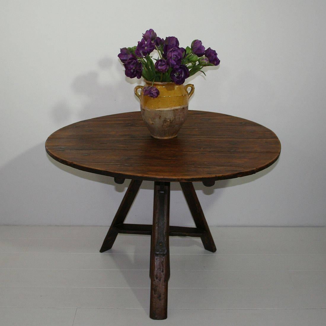 Great folk-art tilt-top table with stunning patina and color. Nice tripod base and wrought iron latch or support. Weathered but despite of its age in a relative good condition.
