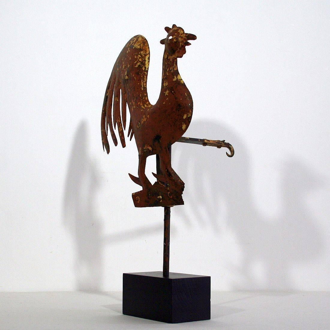 Beautiful sheet iron rooster with great patina. Traces of original painted surface. Early blacksmith made and truly a one of a kind weathervane. France around 1850
Measurement is inclusive the wooden base.