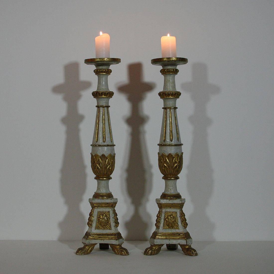Beautiful pair of two neoclassical Louis XVI style candlesticks with their original gilding, Italy, circa 1780. Weathered, without peaks.