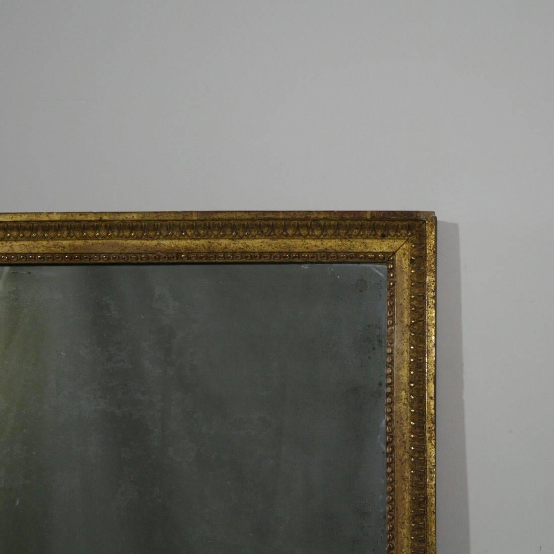 Beautiful gilded classical mirror with its original mirror glass, France, circa 1780-1800. Despite of its high age in a relative good condition.