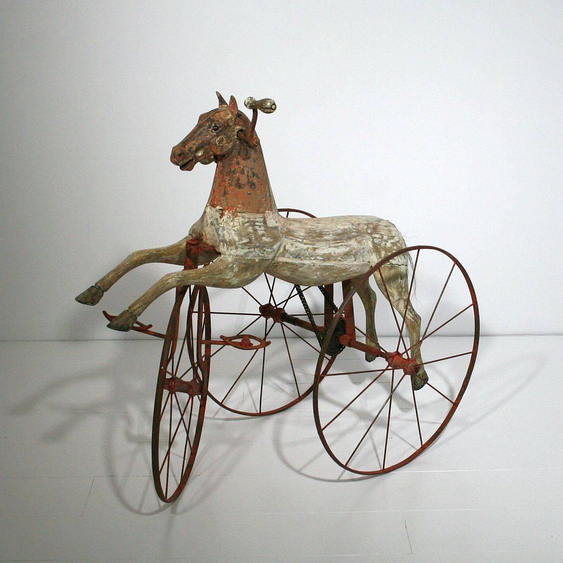Beautiful and complete tricycle horse with its cast iron details and glass eyes with a stunning patina. Completely original and without any repairs or alternations.

This type of 19th century French velocipede tricycle horse was originally