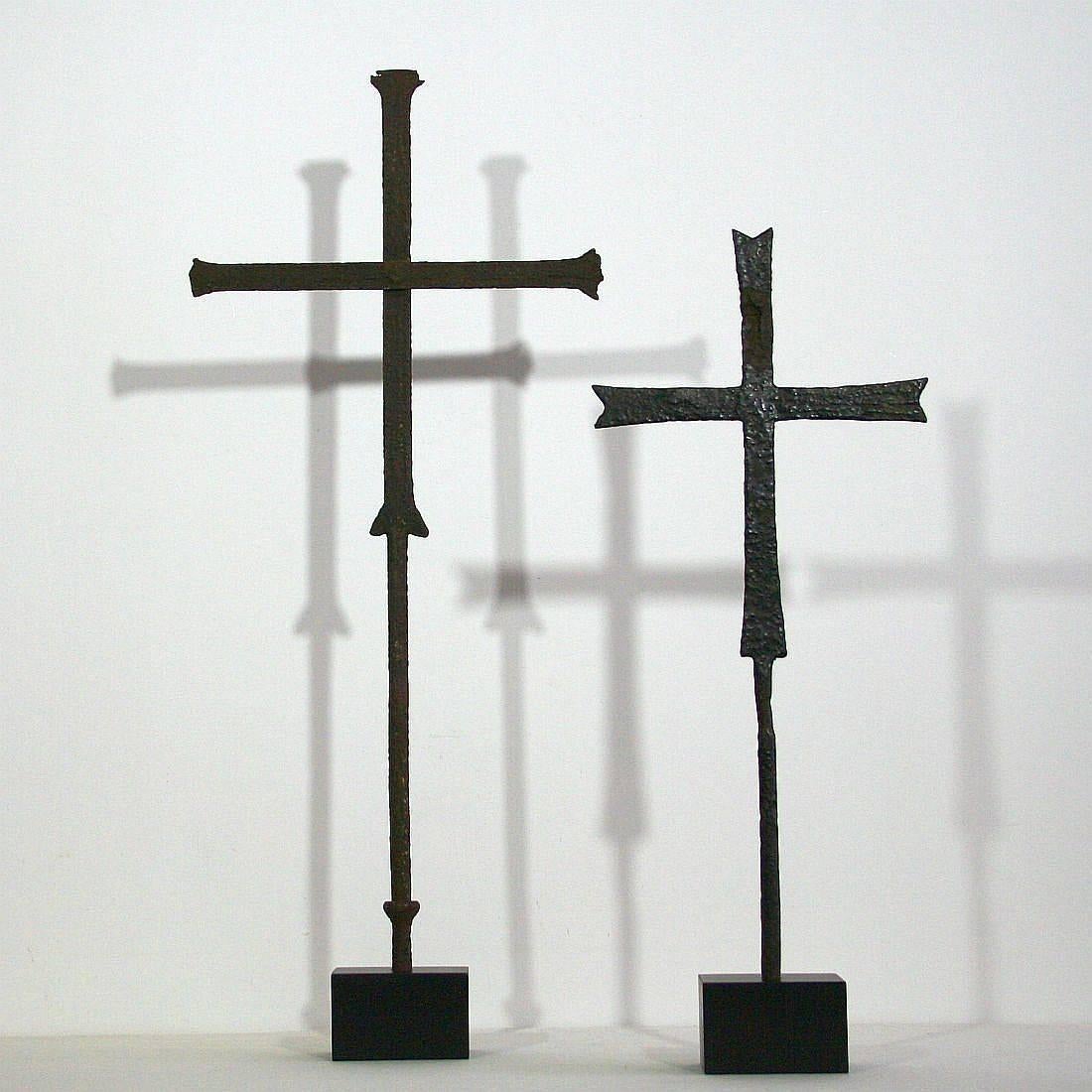 Unique pair of ancient hand-forged iron crosses from a Church. France, circa 1500-1700. Weathered . Measurement here below is inclusive the wooden base.