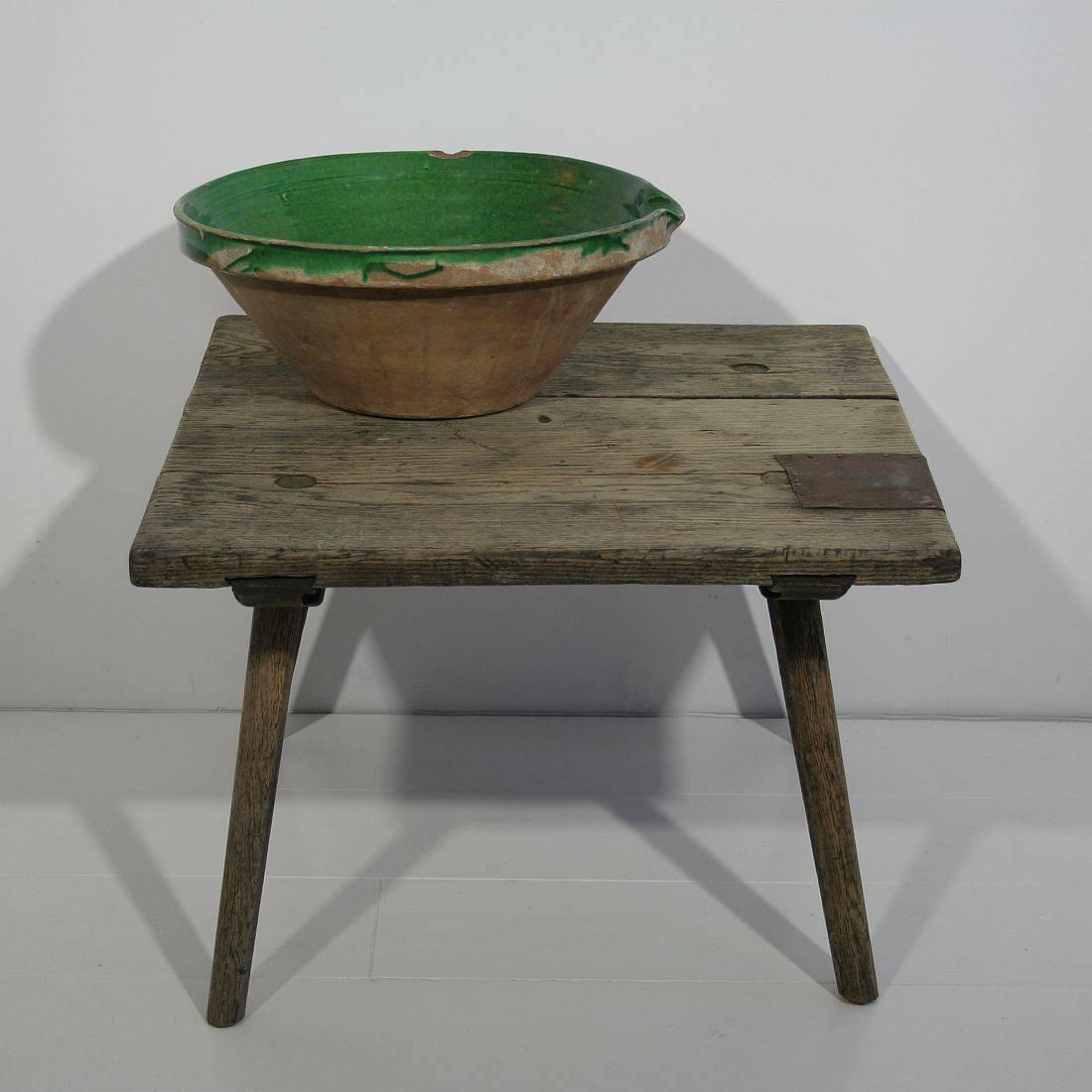 Rustic small oak table. Beautiful weathered piece with a very nice repair at the top. This would be a very nice small side table or coffee table, France, circa 1800. Weathered, losses and old repair.