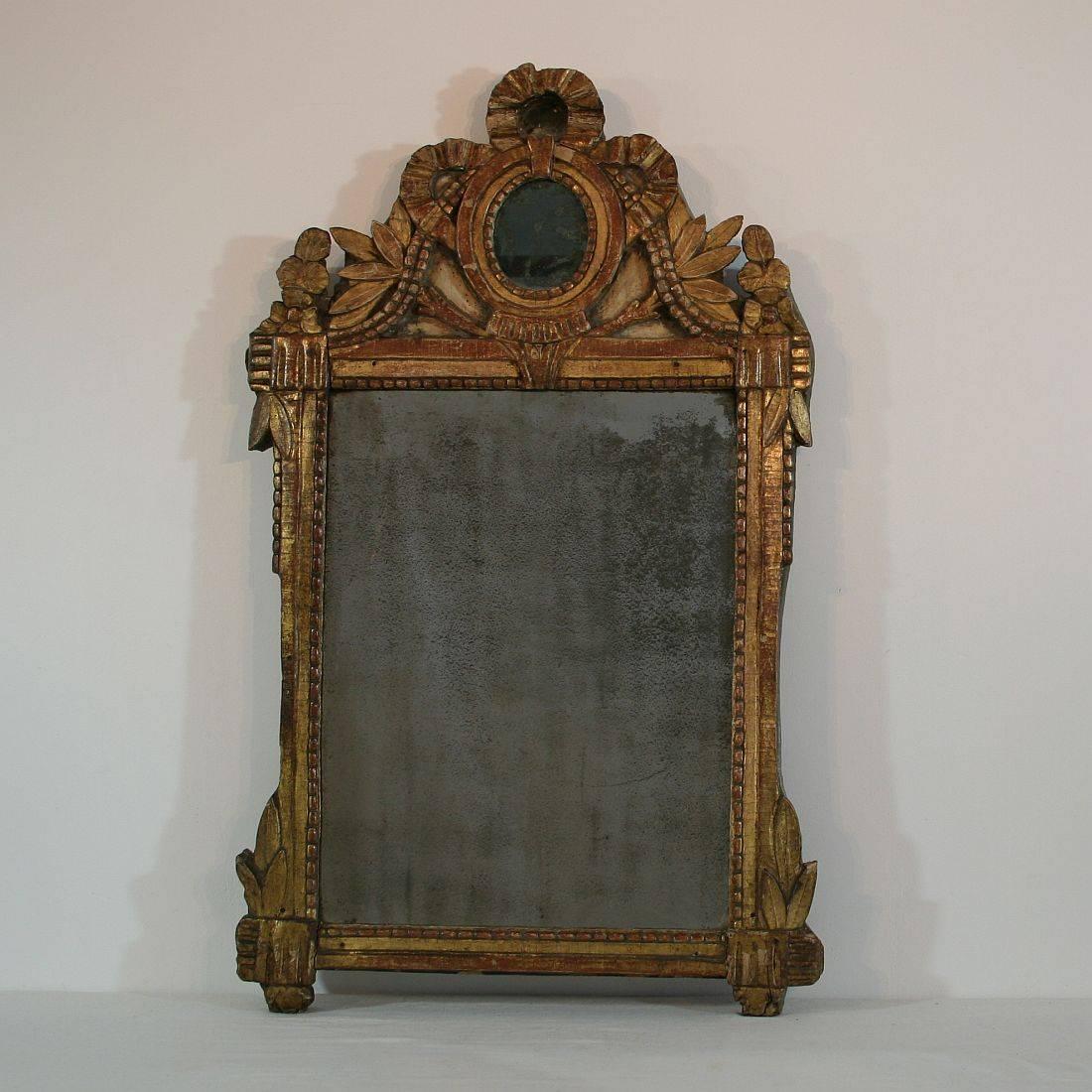 Beautiful period piece. Original gilding, original mirror glass. Great weathered patina, France, circa 1780
Weathered, small losses and repairs. weathered original mirror glass.