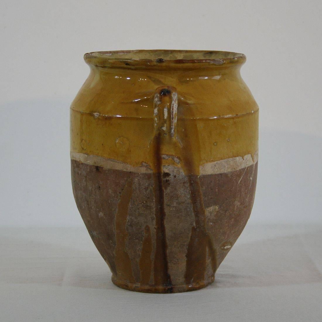 Beautiful weathered confit jar. Confit jars were used primarily in the South of France for the preservation of meats such as duck or goose for dishes such as cassoulet or foie gras. The bottom halves were left unglazed, due to the fact that the pots