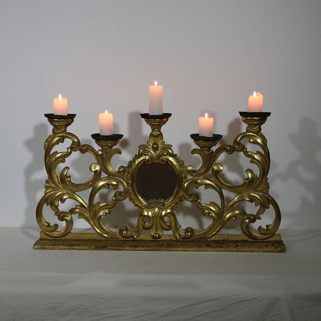 Unique and beautiful Baroque giltwood candleholder for five candles with a mirror, Italy, circa 1750. Weathered, small losses and old repairs.