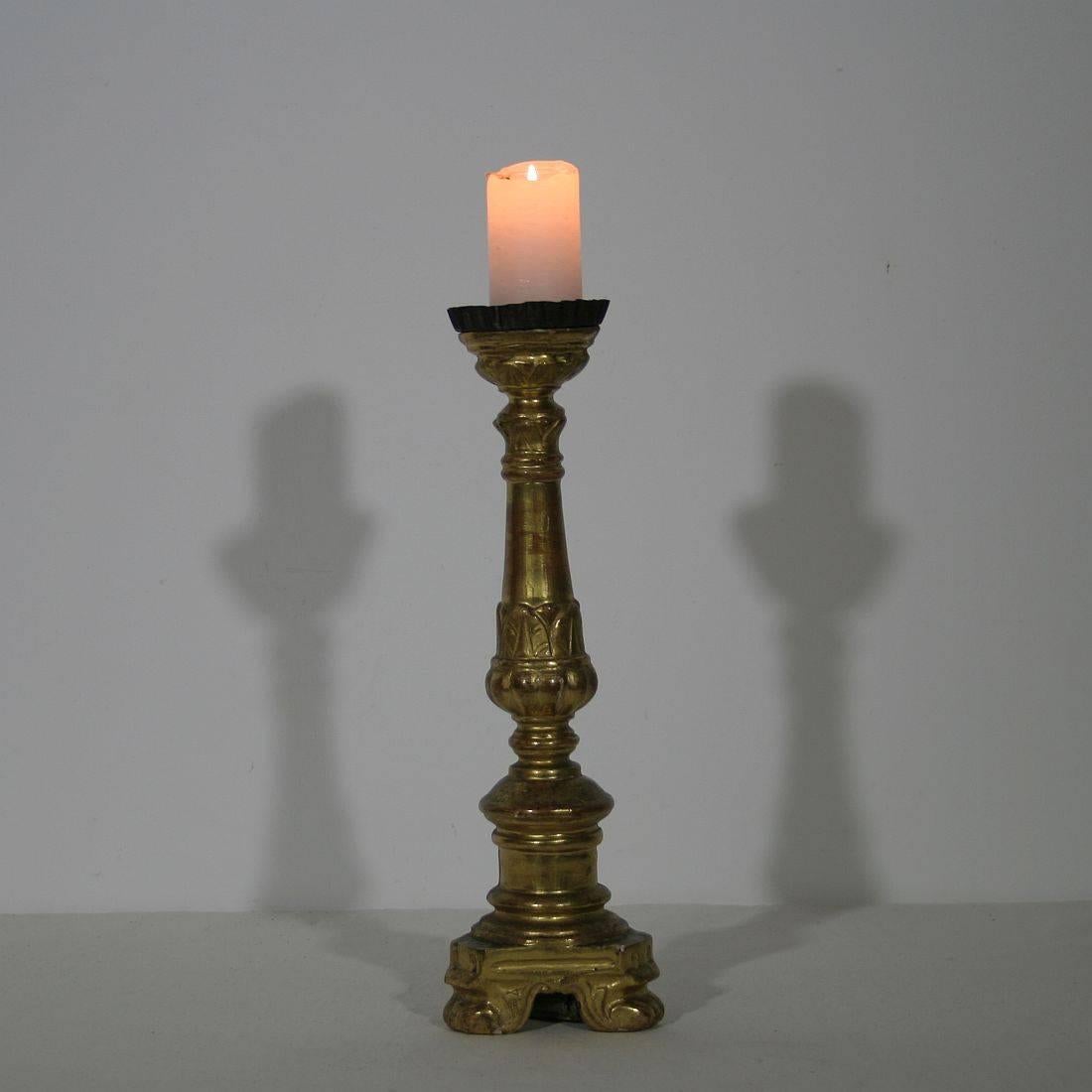 This small giltwood Italian candlestick was originally used on the altar of a church. It was hand-carved and exquisitely gilded on only one side as a means of economy for the Church. Great piece. Weathered and small losses