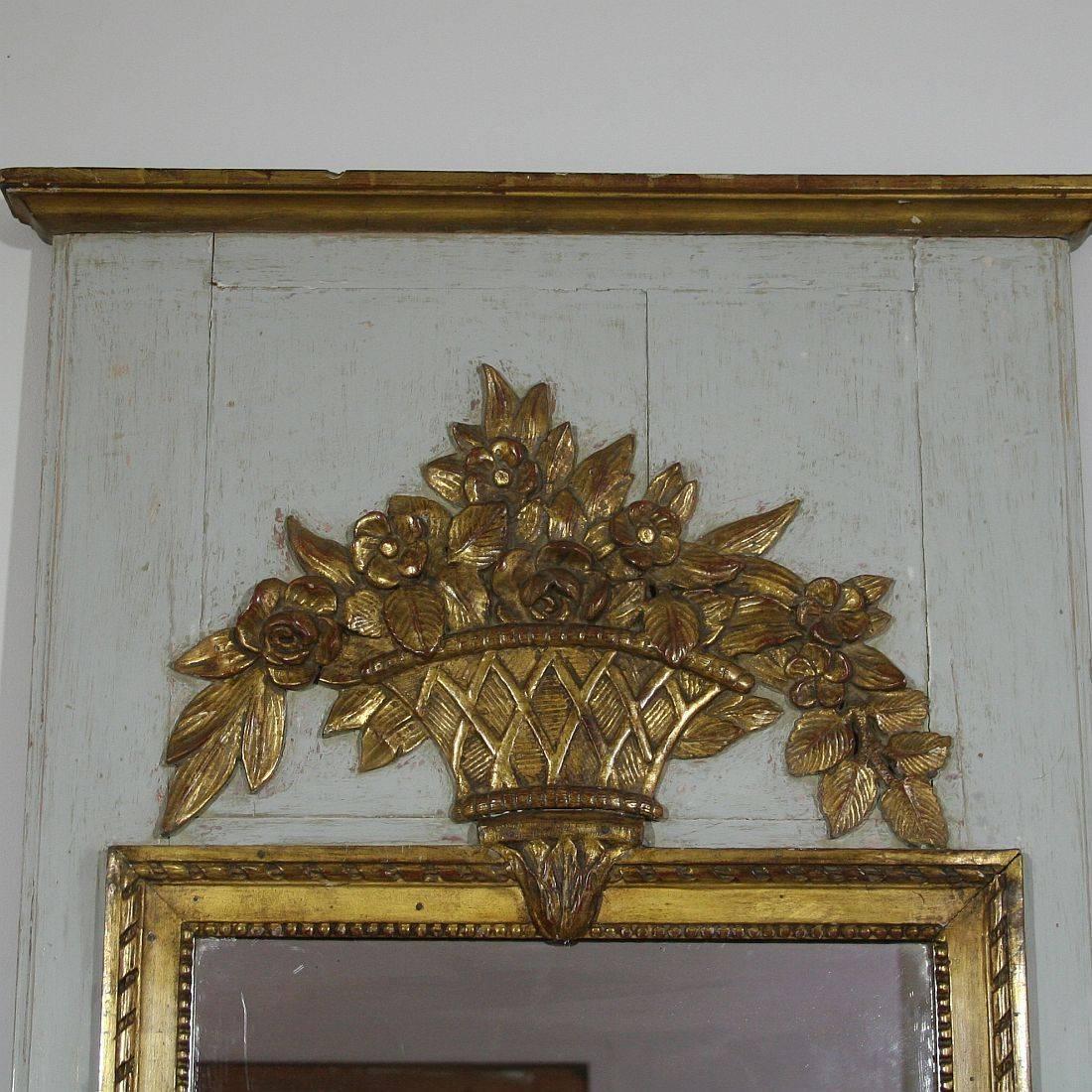 Beautiful 19th century trumeau mirror with great weathered look and hand-carved ornaments, France, circa 1800-1850
Weathered, small losses. Original mirror glass.


