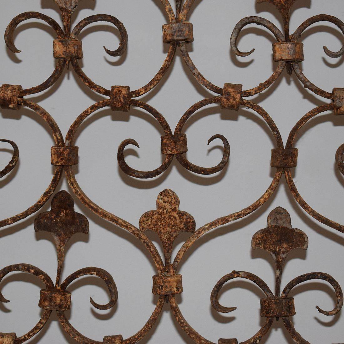 One of a kind hand-forged iron fence from a church interior decorated with hearts and fleur de lyse patterns. Stunning patina and very good condition. Once used to protect a small altar or relics, France, circa 1750.
Weathered but good condition.