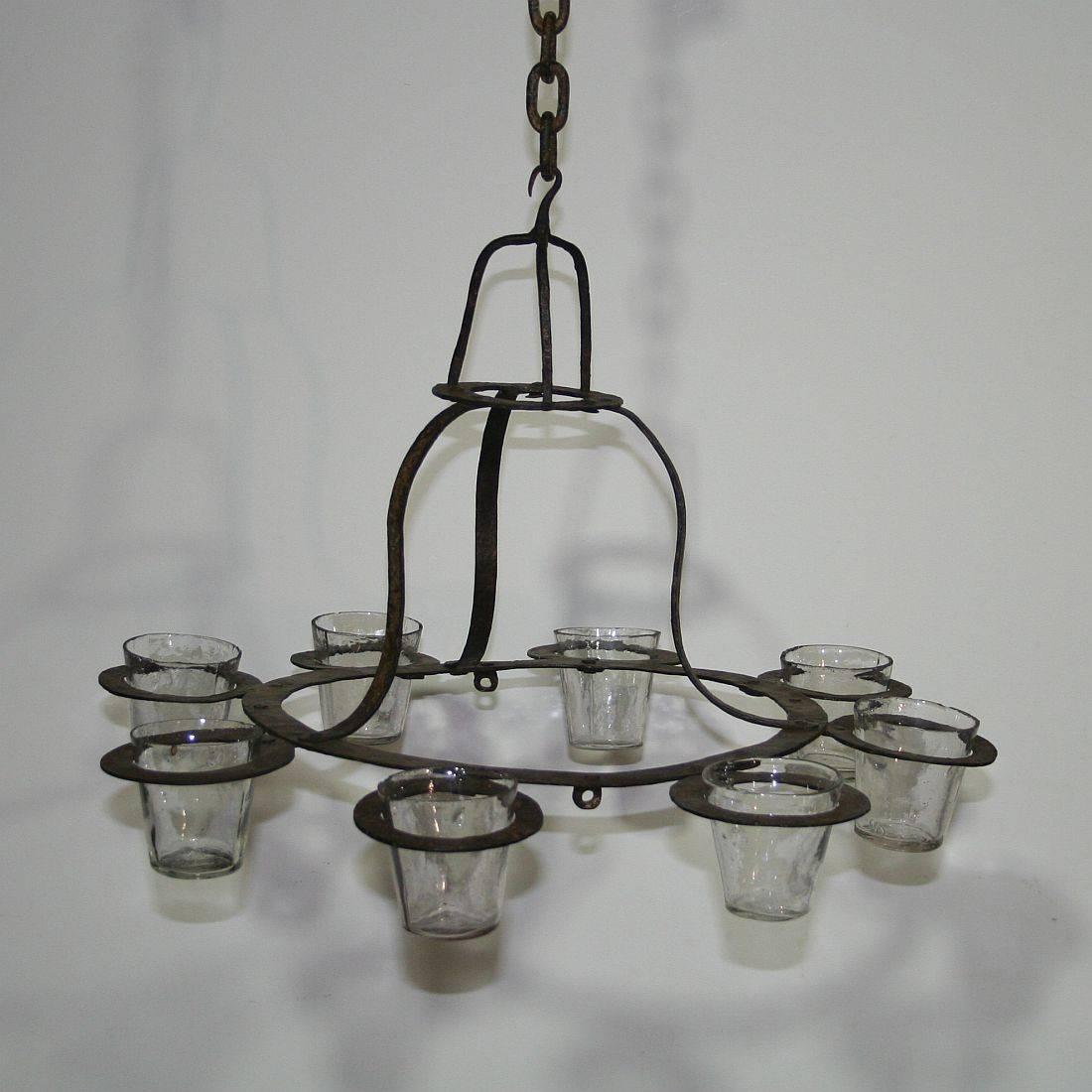 Unique 18th century hand-forged iron chandelier with beautiful glass cups of later date, 
France, circa 1750, glass cups of later date
Weathered, old restorations.
More pictures available on request.