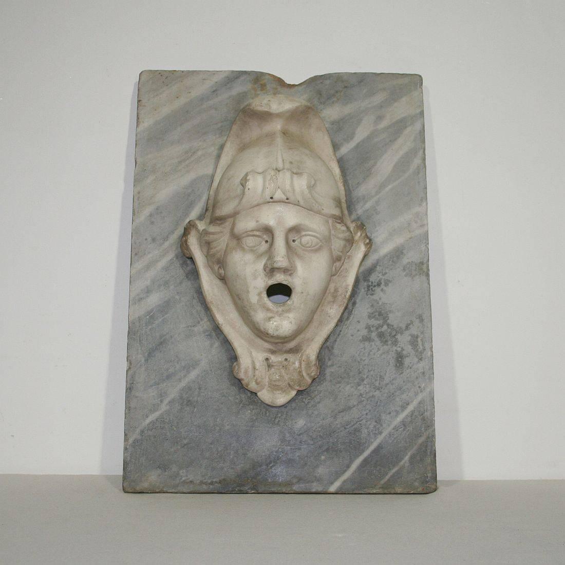 Spectacular and unique Carrera marble fountain head on a grey marble plaque.
Italy, circa 1650-1750
Weathered, small losses and old repairs.
More pictures are available on request.
