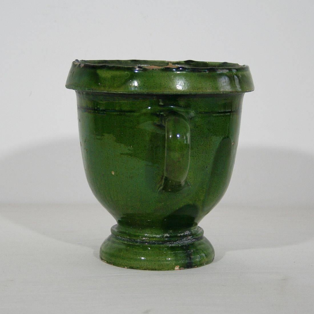 A small French green glazed terra cotta garden urn from Anduze, France. The in and outside of the urn are in a good condition and ready for use in your garden.
 
