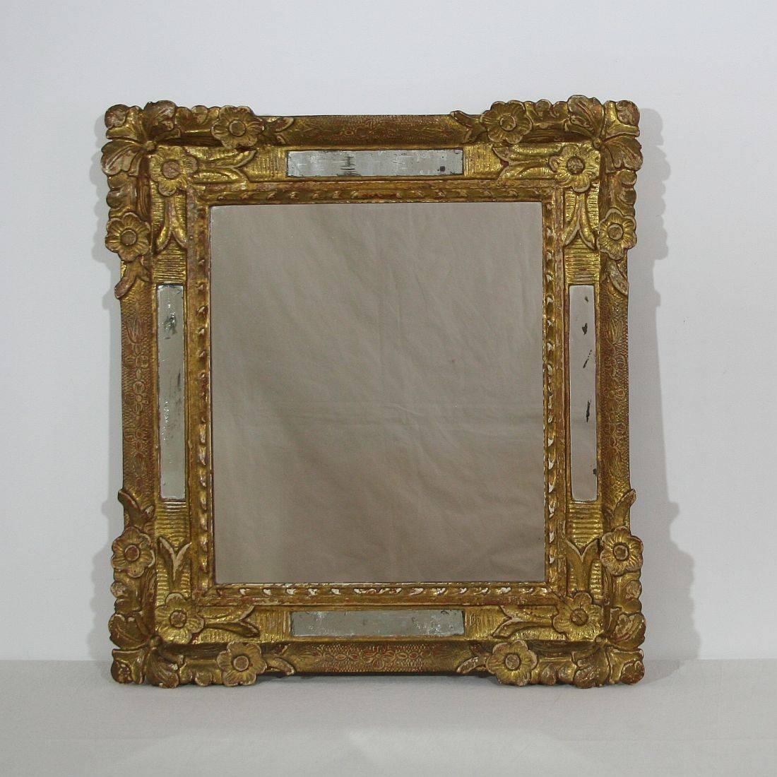 Beautiful 18th century gilded mirror. France circa 1700-1750, middle mirror-glass of later date. Weathered.