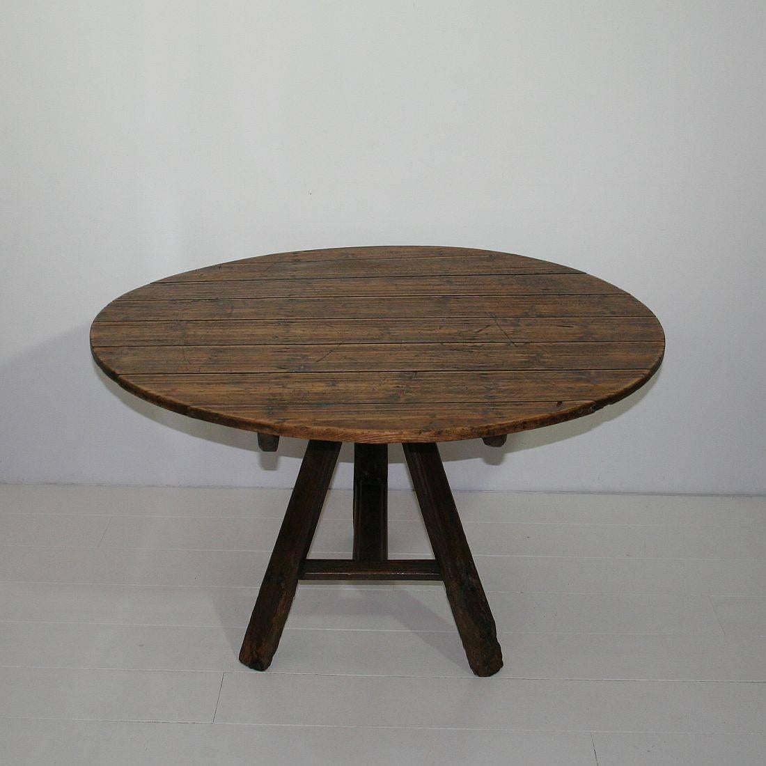 Great folk-art tilt-top table with stunning patina and color. Nice tripod base and wrought iron latch or support. Weathered but despite of its age in a relative good condition.