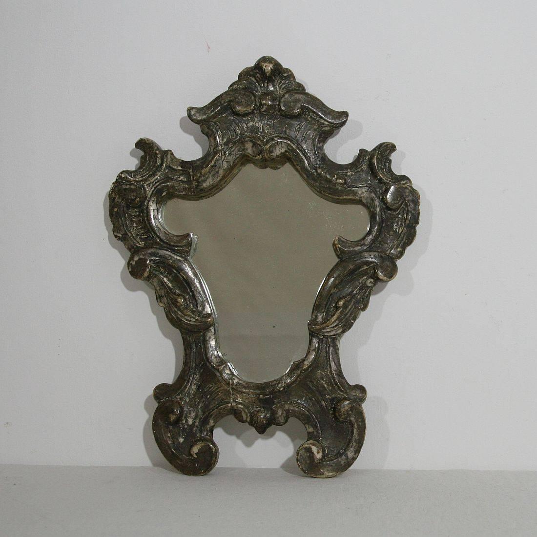 Beautiful carved wooden mirror with original silver
Italy, circa 1750
Weathered and old repairs.