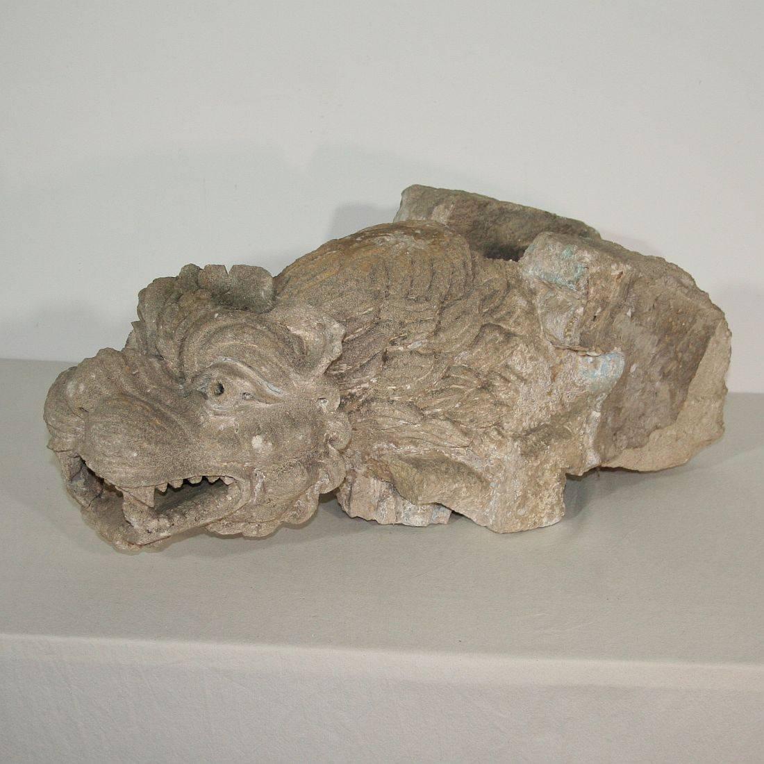 Unique and extremely rare carved stone feathered gargoyle in Romanesque style. Great expression and traces of old paint.

This gargoyle, a word derived from the French 15th century word 'Gargouille' (throat), is a hybrid, possibly a griffin or a