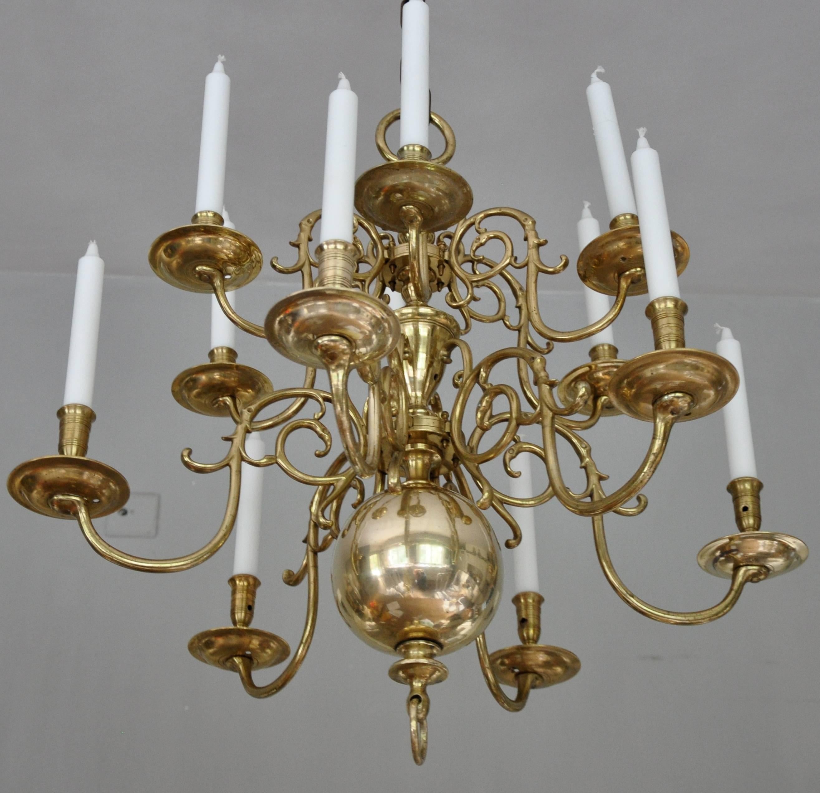 Twelve-light Dutch brass so called "ball" chandelier with two tiers of pegged S-shaped branches, a ball and baluster stem. The chandelier has readily drilled holes for electricity. Good proportions and quality.
