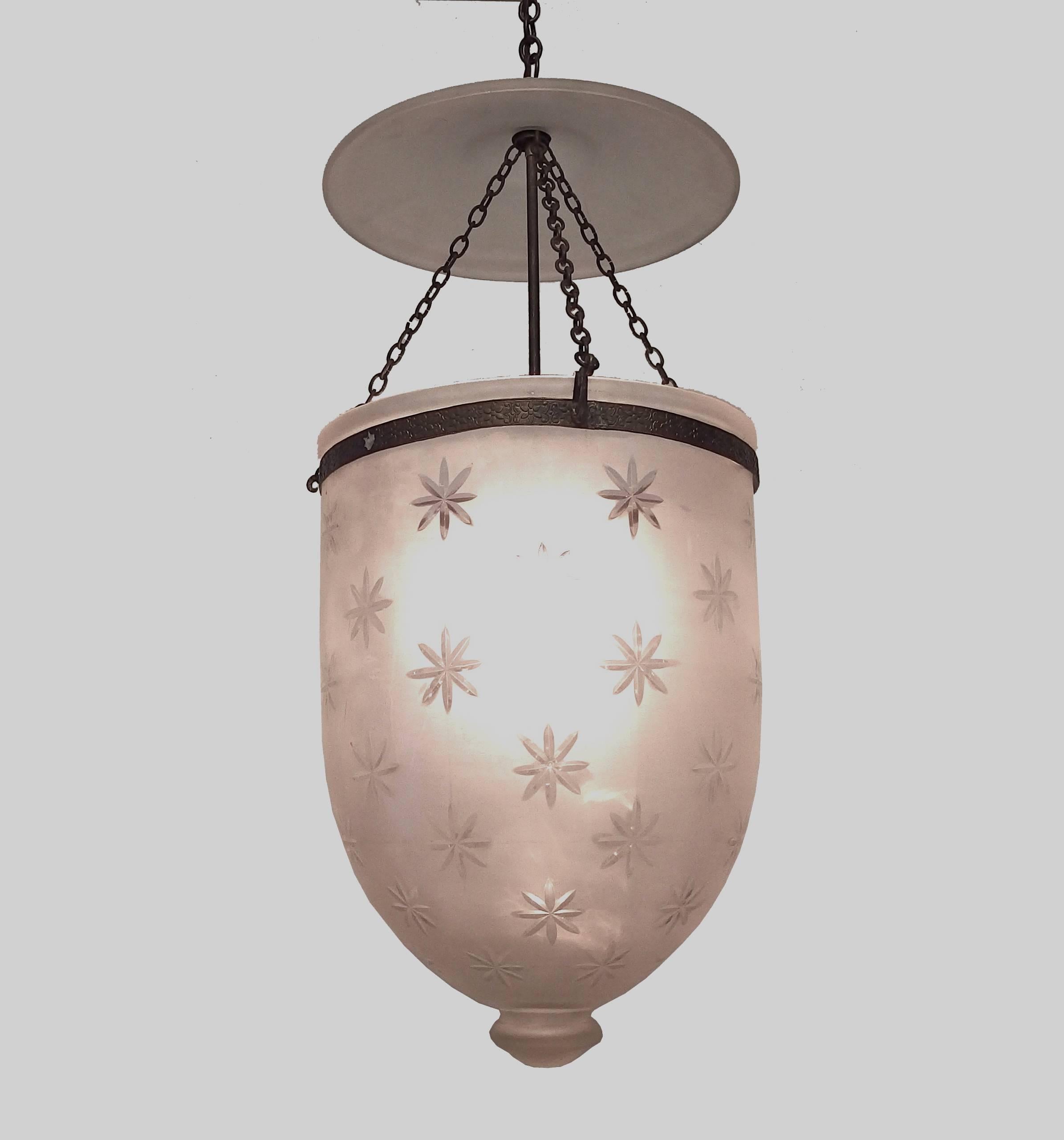 Beautiful French etched crystal bell lantern with clear stars. The frame and chains are in brass.