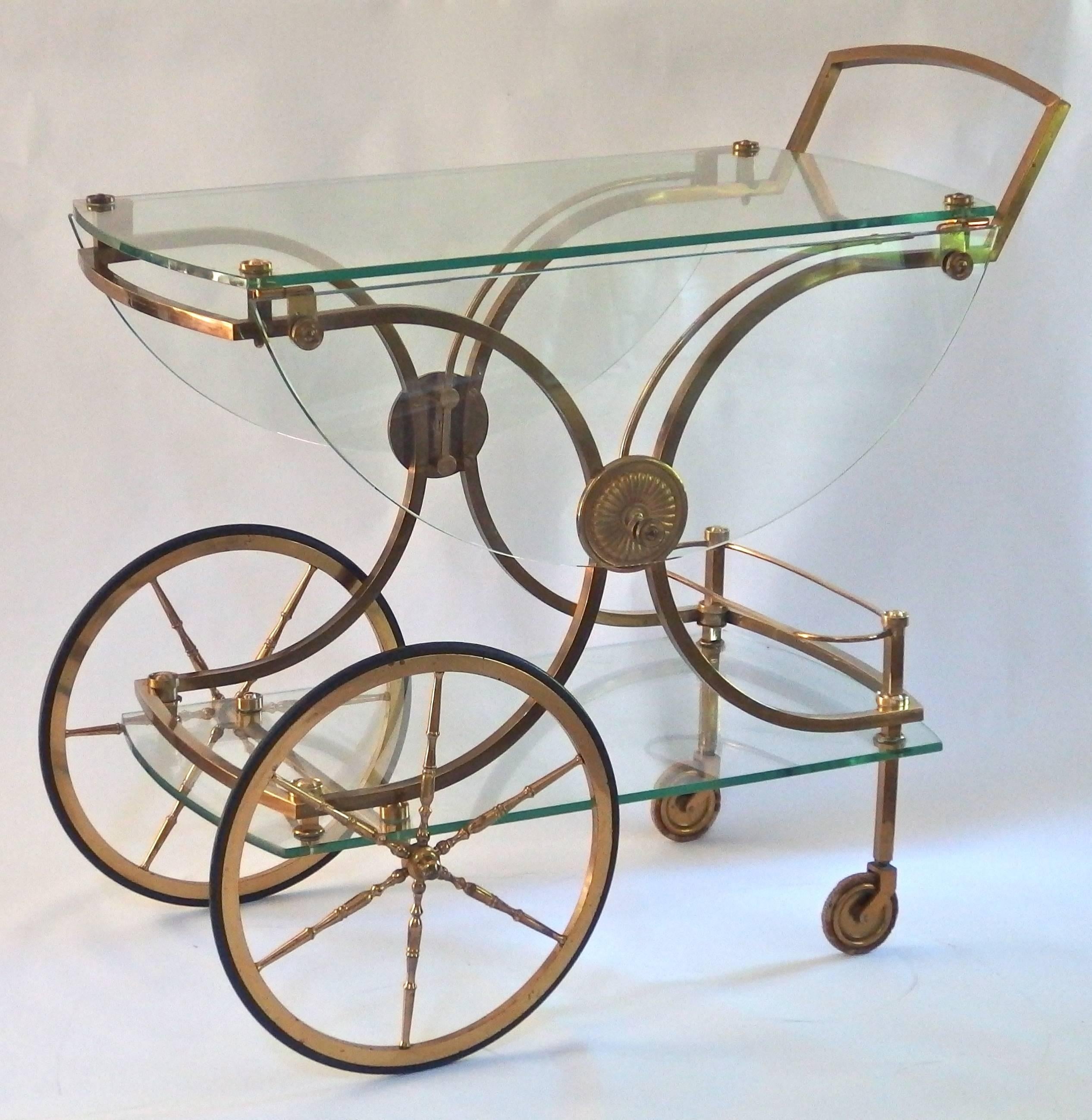 Outstanding French clear glass and brass drinks trolley with folding sides attributed to Maison Charles.

 Dimensions: H 80, W 90, D 48 
The height of the top shelve is 70 cm and the width when folded out is 95cm.