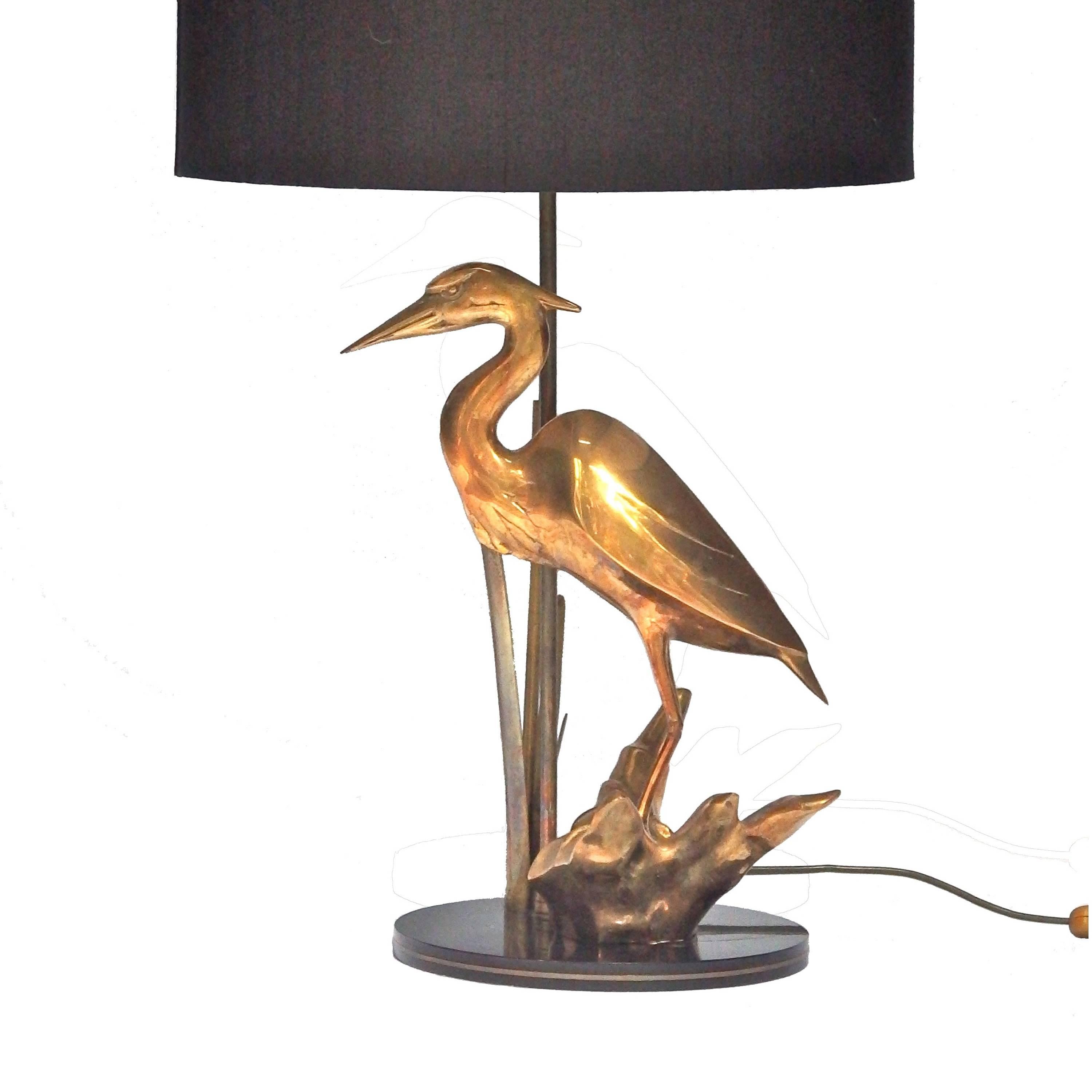 1970s French brass table lamp with heron and black silk shade.
Measure: Total height inclusive the shade is 66cm and diameter shade is 40cm.