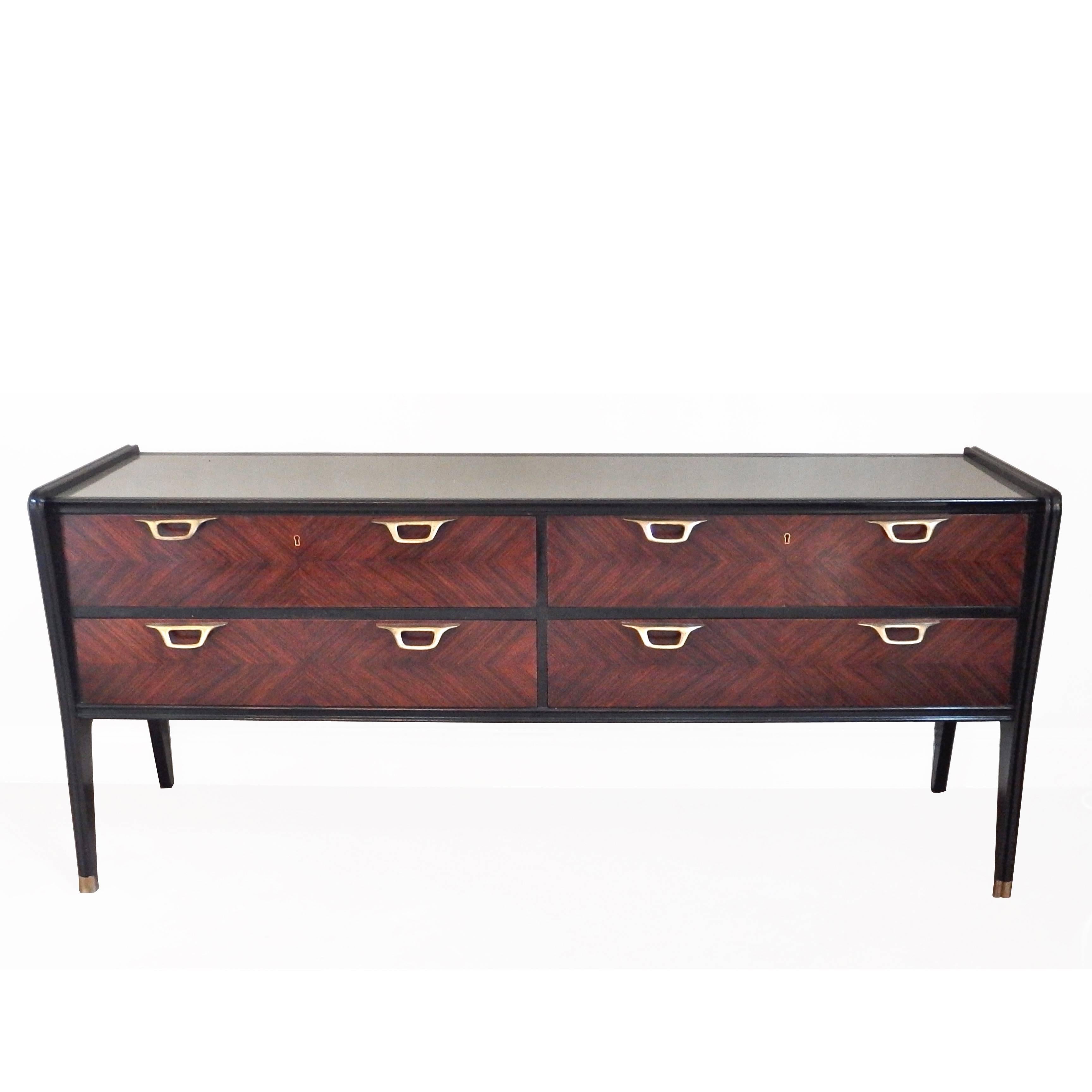 Beautiful Italian rosewood sideboard with herringbone parquetry front, silver-grey glass top and brass handles and sabots, attributed to Paolo Buffa. 

Period: 1950s

Dimensions: H 80, W 185, D 54cm.