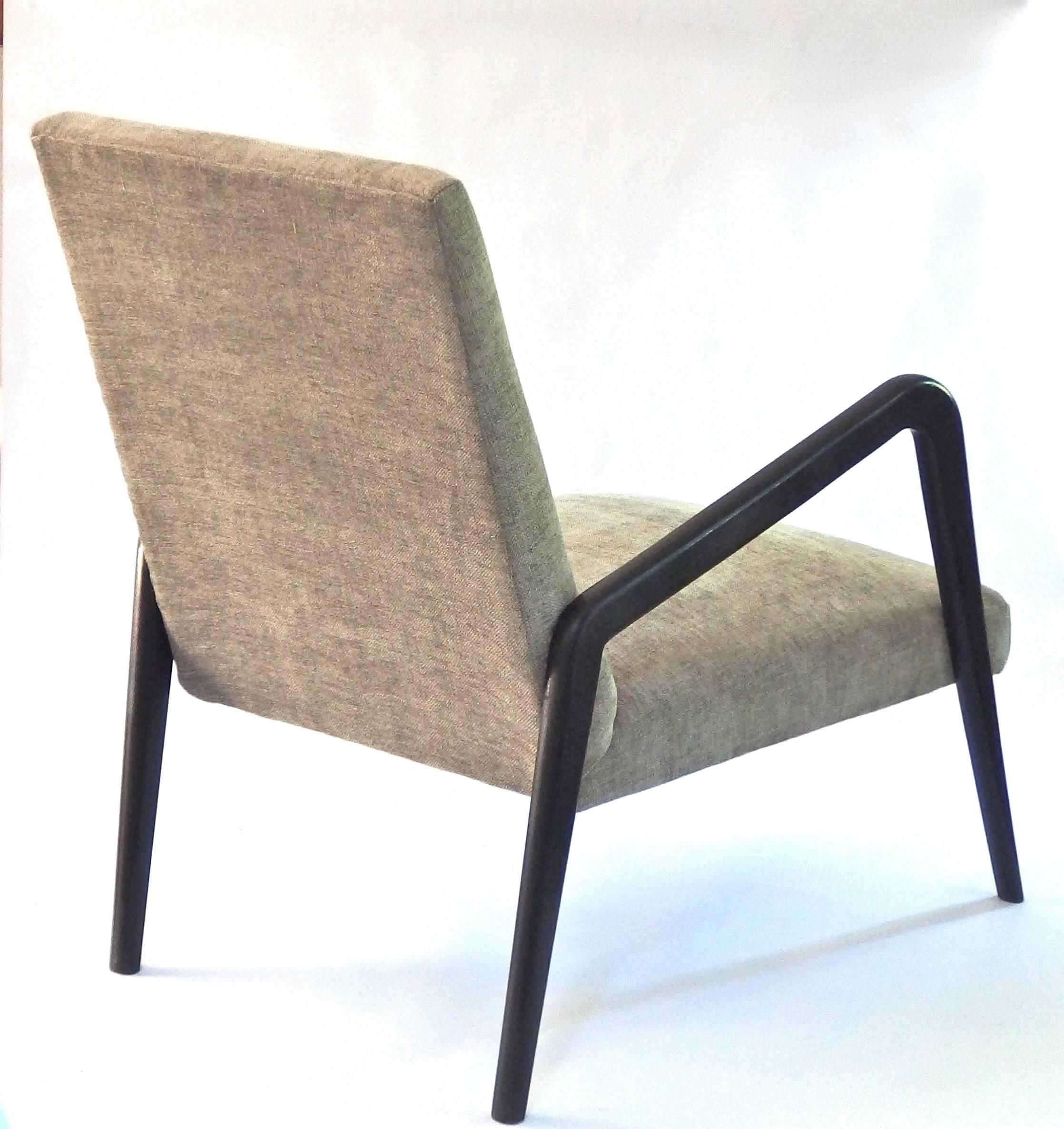 Pair of very elegant black Italian lounge chairs newly upholstered with a warm grey chenille fabric. Very comfortable, great design!