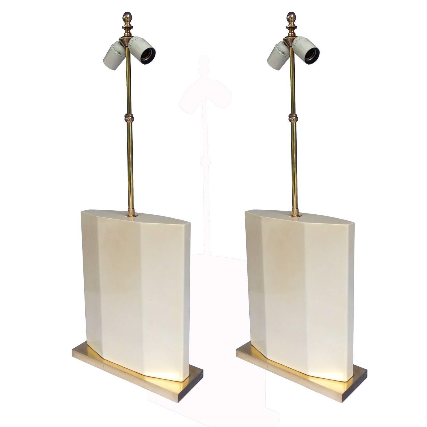 Pair of 1970s white enamel table lamps on brass feet by Roger Vanhevel. The height without the stem is 39cm. The blue-grey silk shades with gold lining are H 37, W 53, D 39cm.


