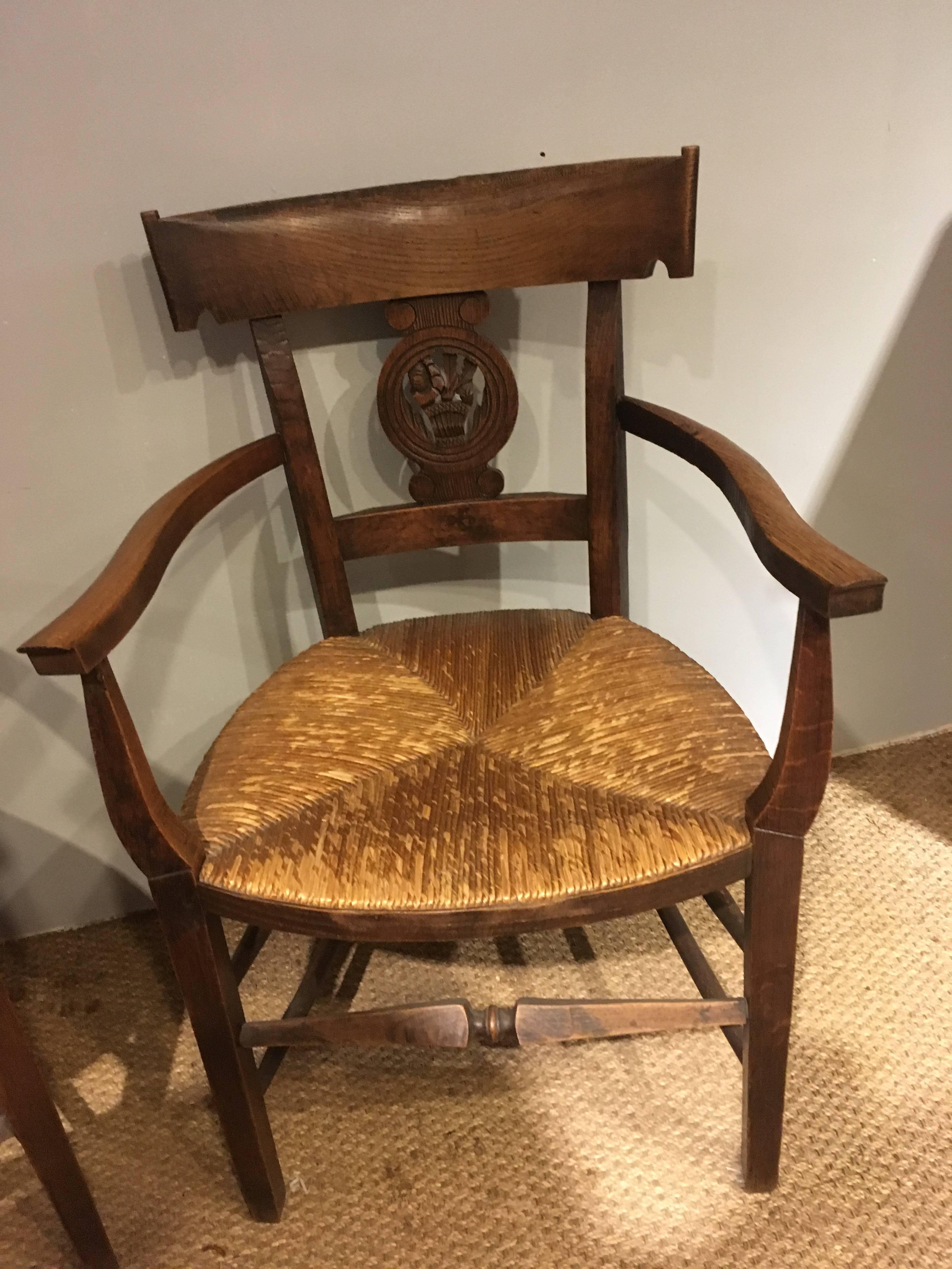 Very stylish pair of oak early 20th century rush seated country carvers chairs 
All the joints are firm and the rush seats are in good order,
circa 1920. 
Measures: Depth 25 inches
Width 21 inches
Height 35 inches.