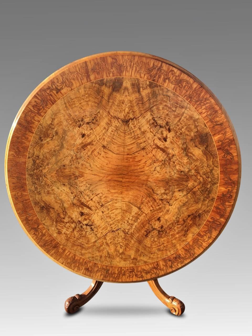 Fabulous circular centre table in walnut and banded in scrolled kingwood marquetry. Tilt top action, English, circa 1870.
This delightful table is in super condition while retaining a rich and mellow antique patination. Would suit as a reception /