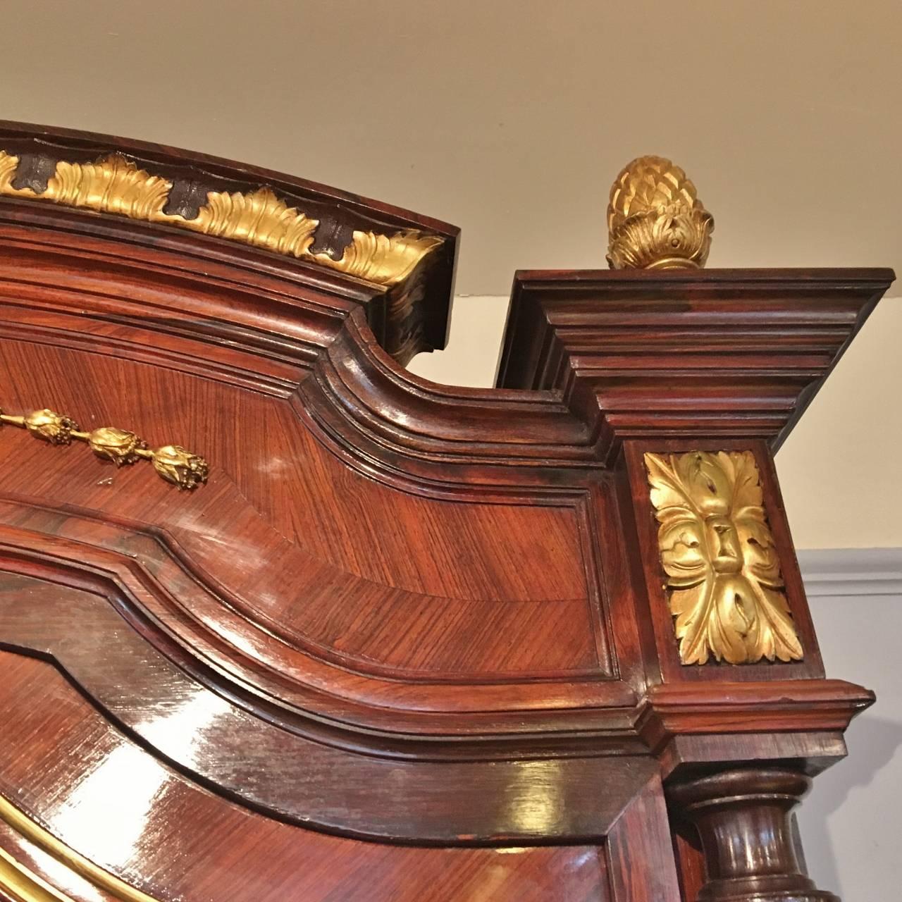A most impressive rosewood library bookcase with ormolu and gilded mouldings.

This delightful bookcase has five substantial and adjustable shelves with great depth and has the benefit of a deep drawer in the base. The door retains its original