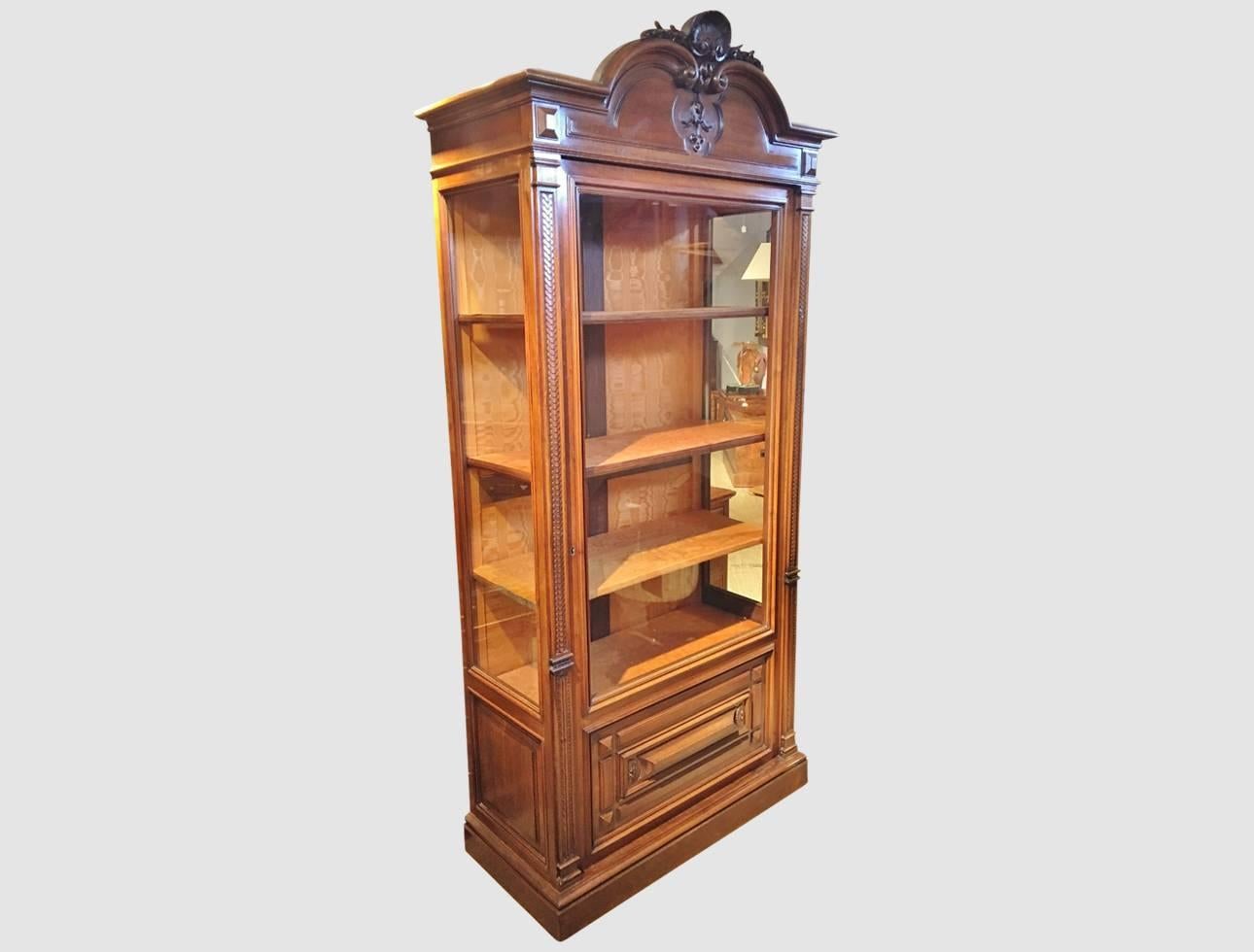 Attractive walnut display cabinet. French, circa 1880.

This cabinet has been well maintained. In straight grain French Walnut, It is compact with Glass side panels giving extra light and visibility. 

The Plush Silk interior is in excellent