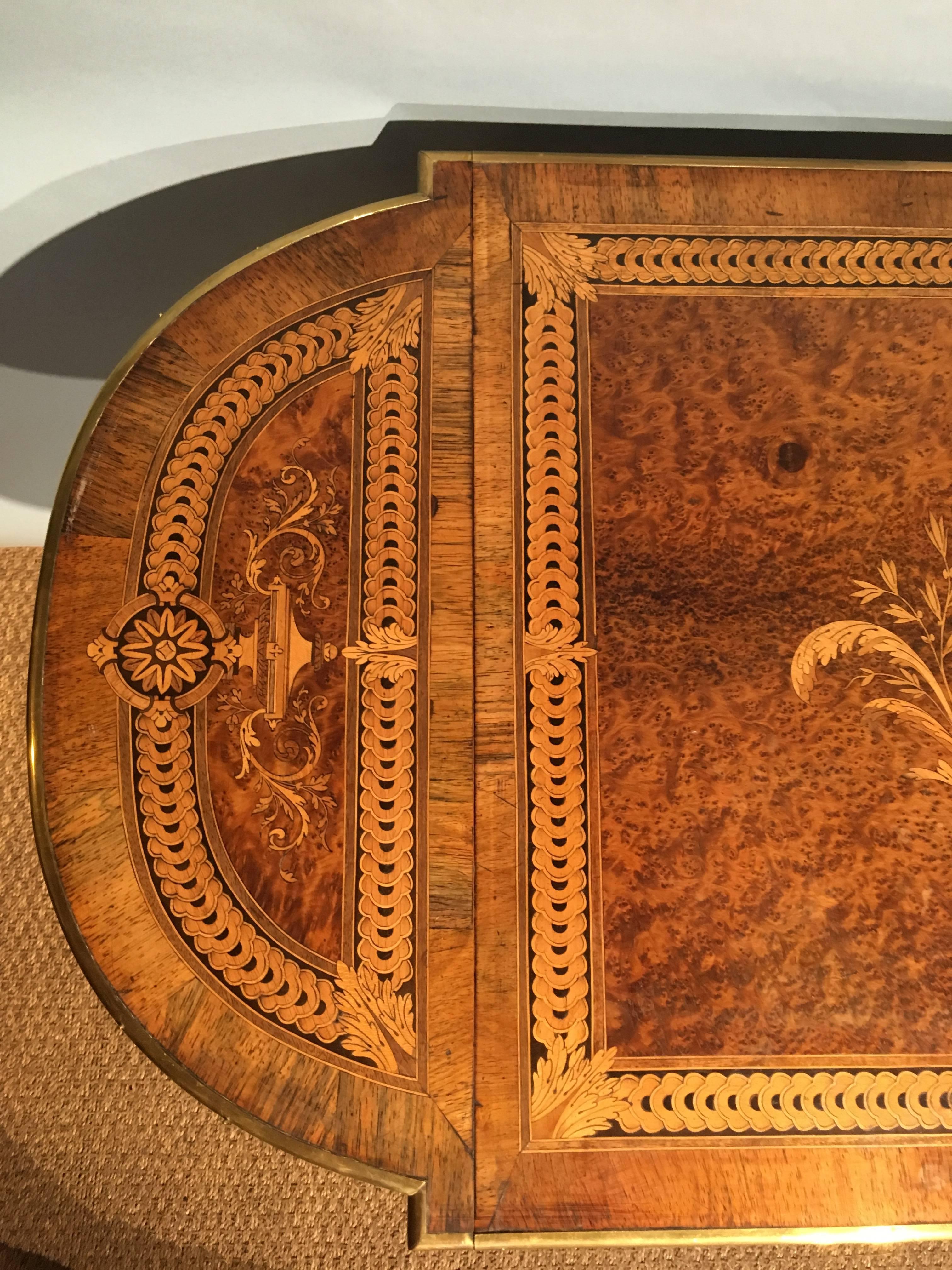 Napoleon III inlaid sofa table, French dating circa 1870s, veneered with rosewood and amboyna, the marquetry is in various specimen woods finished off with brass mounts 

Shown here in 