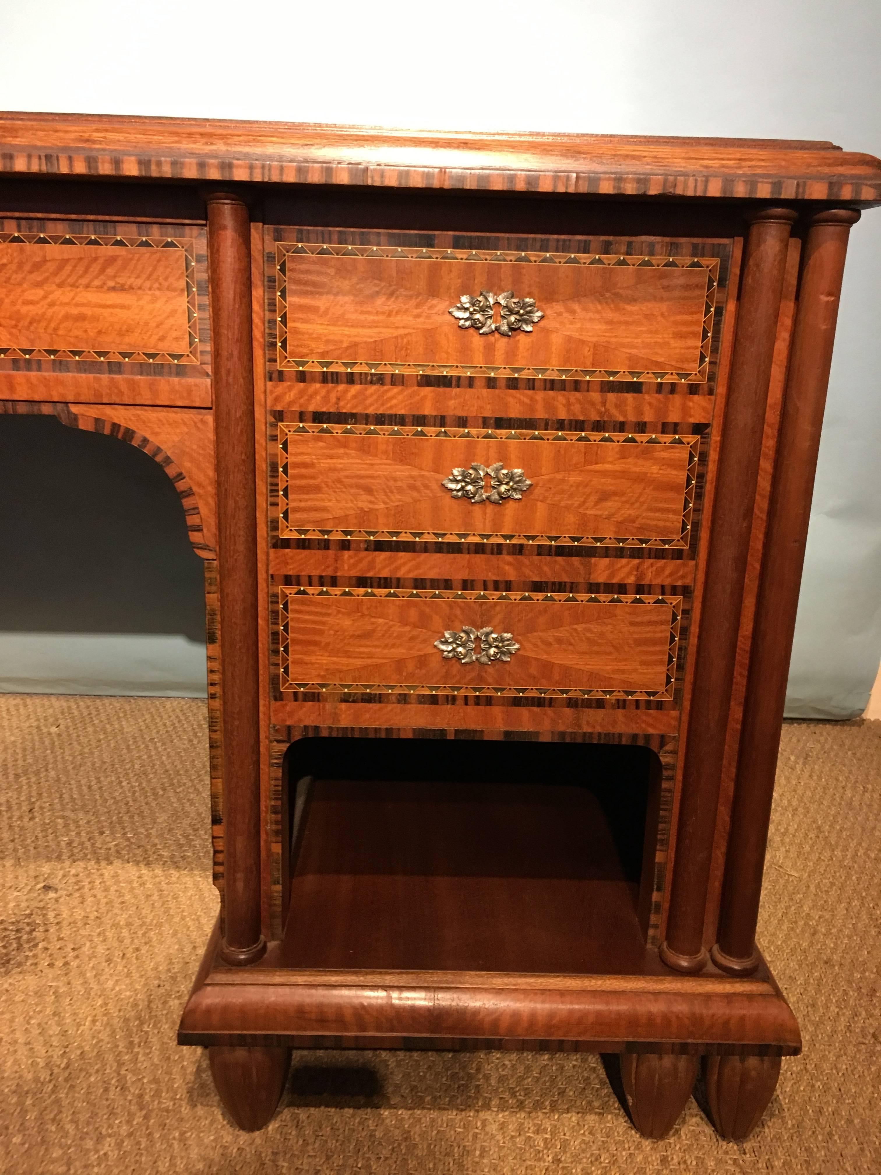 The most fabulous Art Deco pedestal desk 

Dating to around the 1930s, this piece is very much of the period with Macassar Ebony banding intricate inlay detailing ebony & ivorine , original silver plated key escutcheons , keys will be supplied for