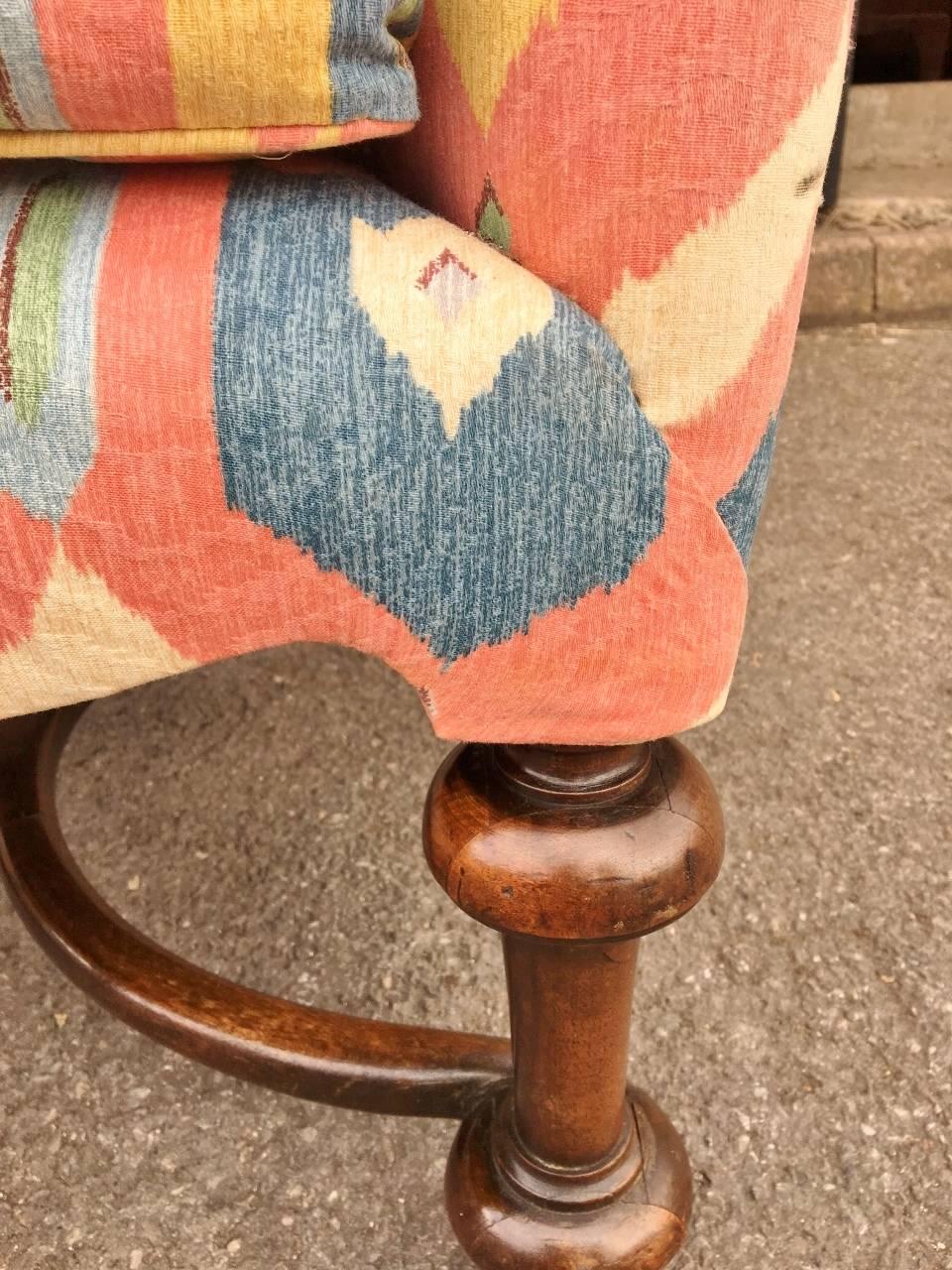 This is a very stylish and large, late 19th century walnut armchair in the Georgian style.. Upholstered for former owners in premium material about 2 years ago,, this delightful chair is a one off. It is also very comfortable with good back support