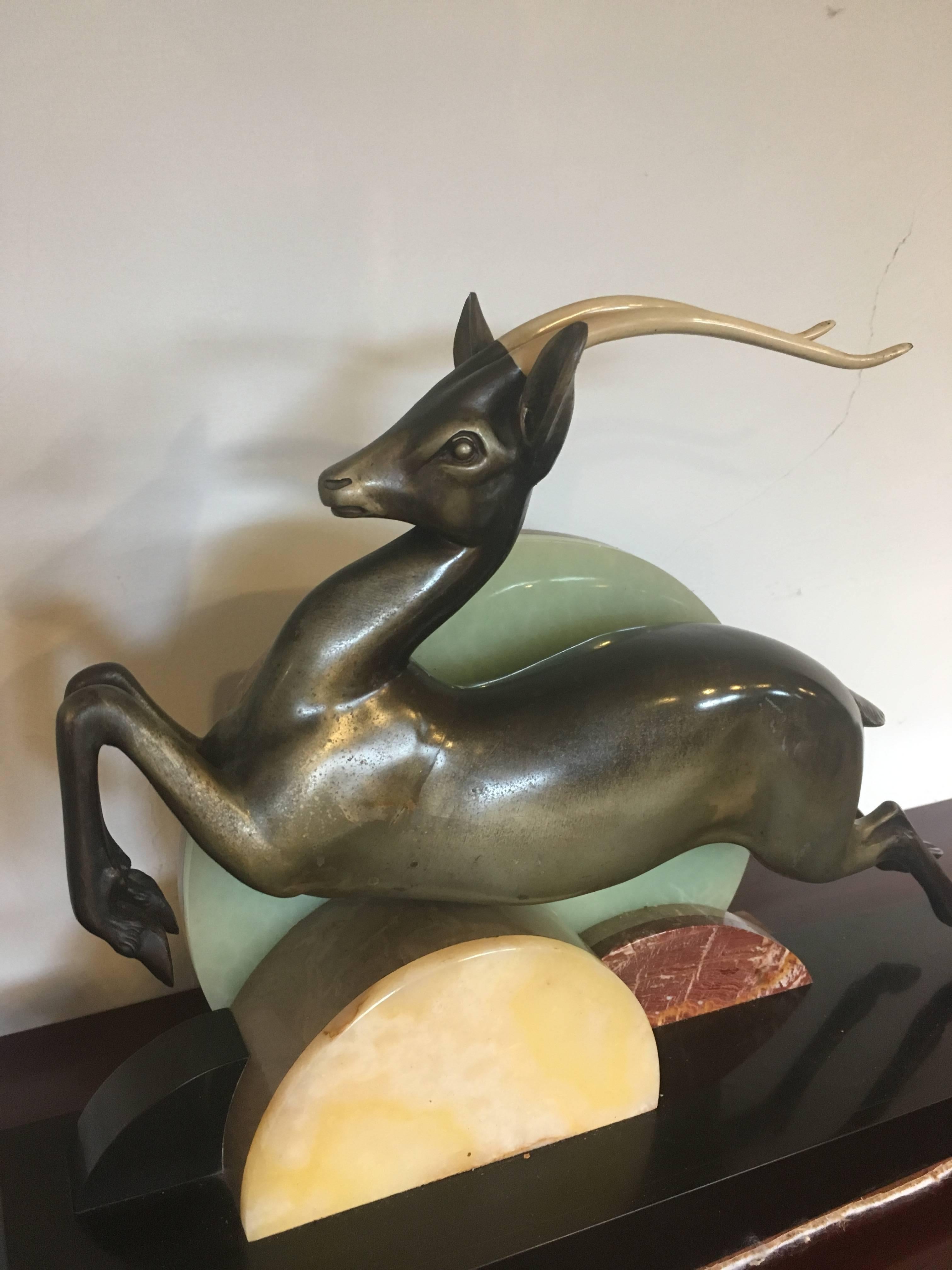 Very stylish Art Deco spelter figure of an antelope on a black slate base with decorative circles of specimen marbles 

Signed on the slate I Richard .. couple of small nibbles to the slate 

Measures: Height 14 inches
Width 21 inches 
Depth 5