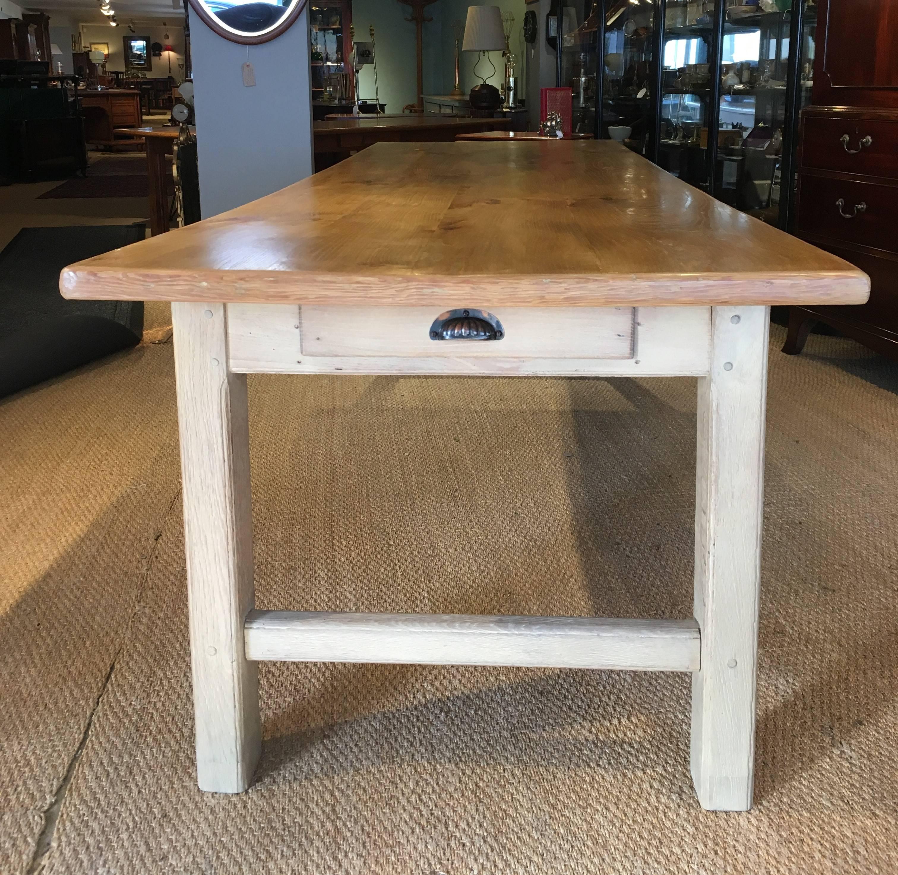 Very stylish late 19th century large farmhouse table

This substantial table dates to around the 1890s with a solid figured Elm top standing on solid oak base which has been limed single drawer to one end 

Will easily seat ten people 12 max