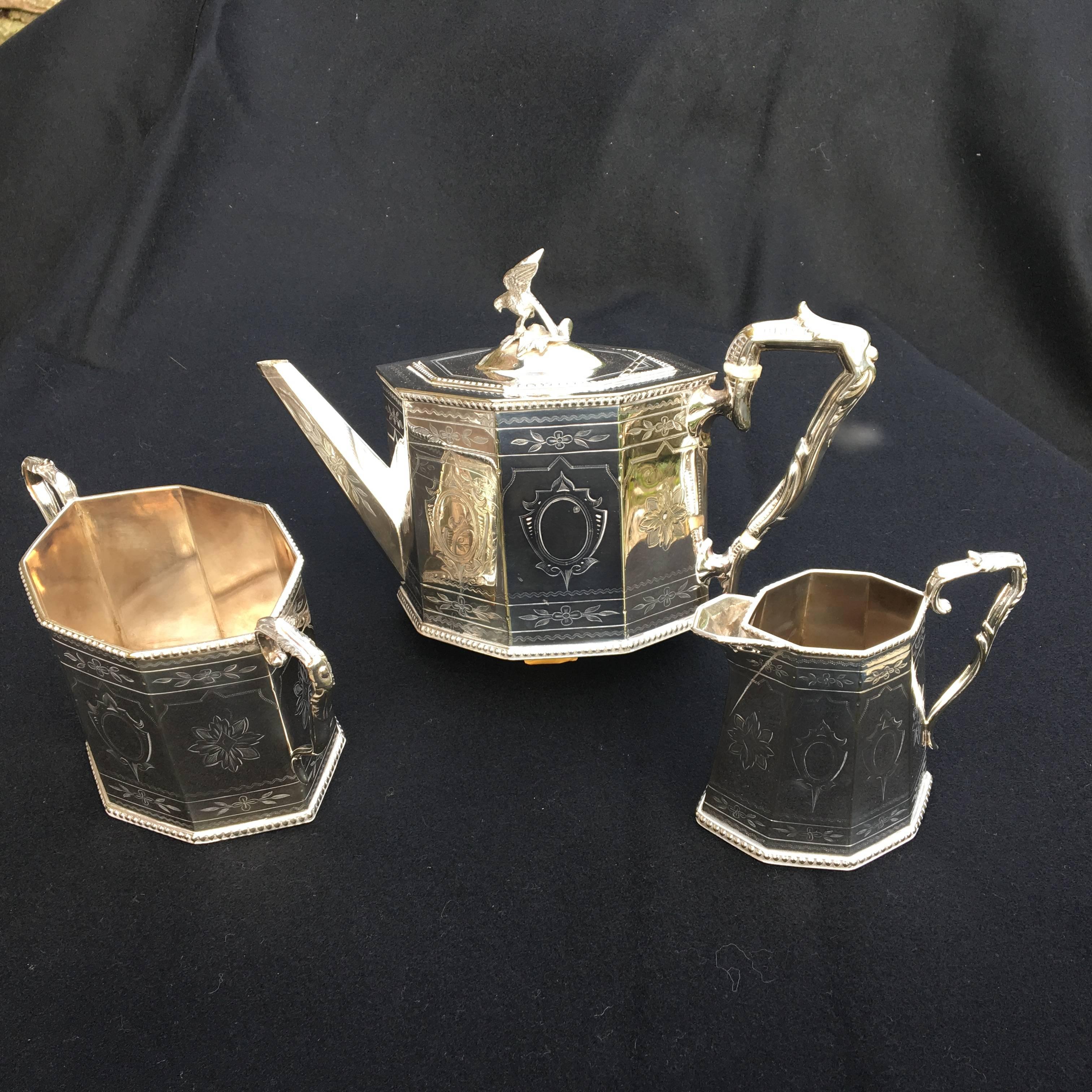 Attractive English silver plated three-piece tea service in excellent condition, circa 1890. Making
tea a special occasion every time. 

A very smart tea service featuring a brightly chased pattern on an octagonal shape with
the teapot handle in