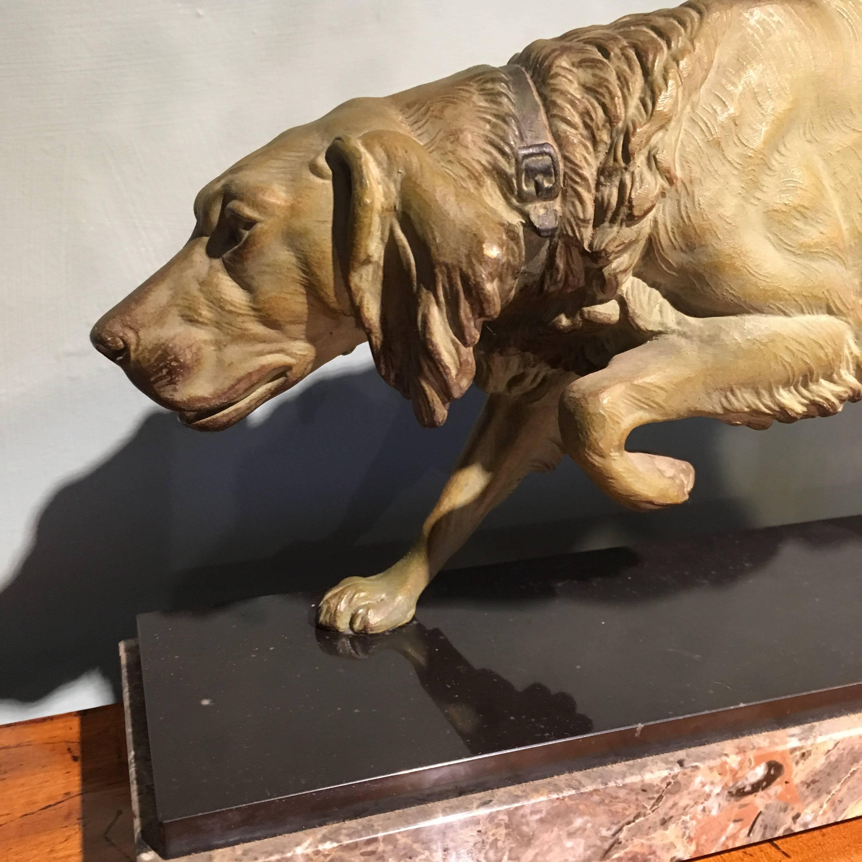 Art Deco spelter figure of a retriever mounted on a slate and marble base 

Signed to the slate C Mosson 

Crack in the marble to the rear and bit of blooming to the slate 

Measures: Height 8 inches 
Width 16 inches
Depth 4 inches.