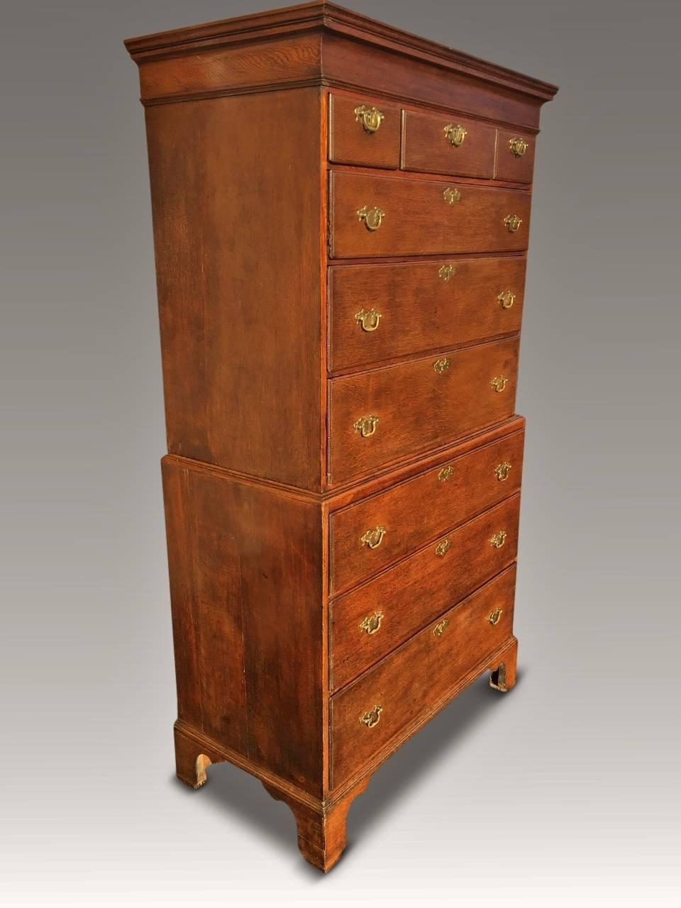 A most attractive antique oak chest on chest which is English and dated to about, circa 1790-1800.

This delightful chest stands on original bracket feet, has brass drop handles upon nine drawers and stands only 73 inches high. All the drawers are
