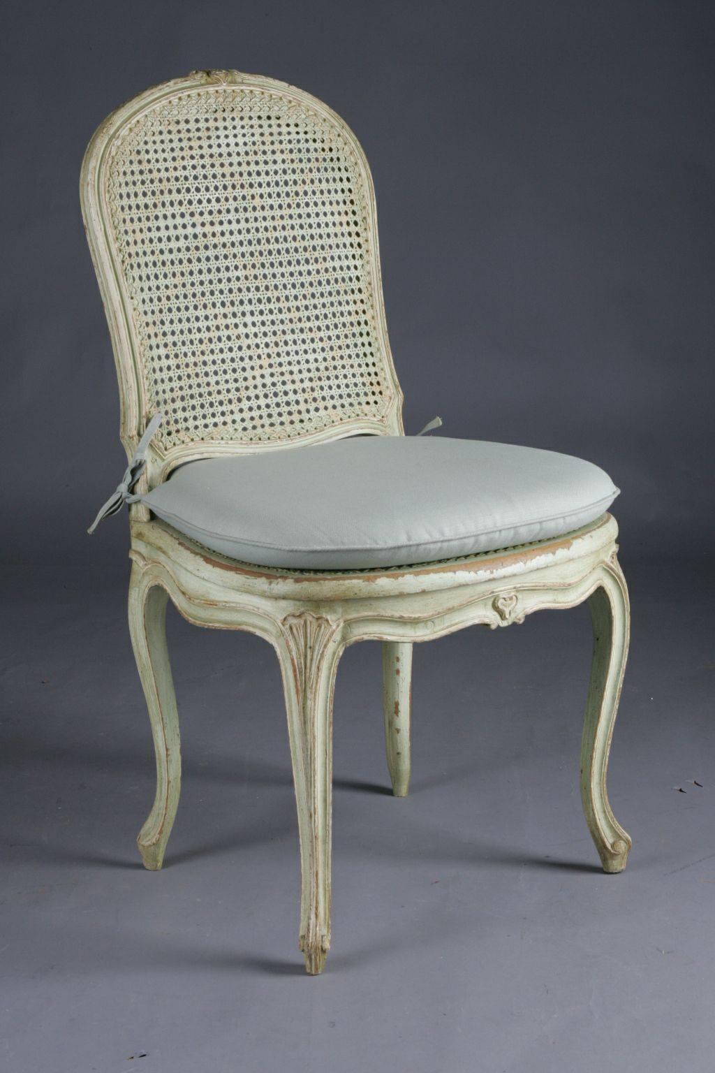 Solid wood, carved and lime green. Passive, curved profile frame with circular floral carving on curly legs. Seat surface braided. A good historical condition with a wonderful warm patina grown over decades.

(C-31).