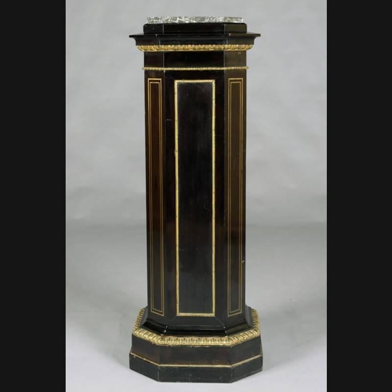 An extraordinary column-style cabinet in classicist style.
Solid, ebonized softwood. Octagonal shaped body on a slightly profiled multi-stepped base. Slightly protruding cover plate enclosed in a marble slab. Rich decorated with a sculptured bronze