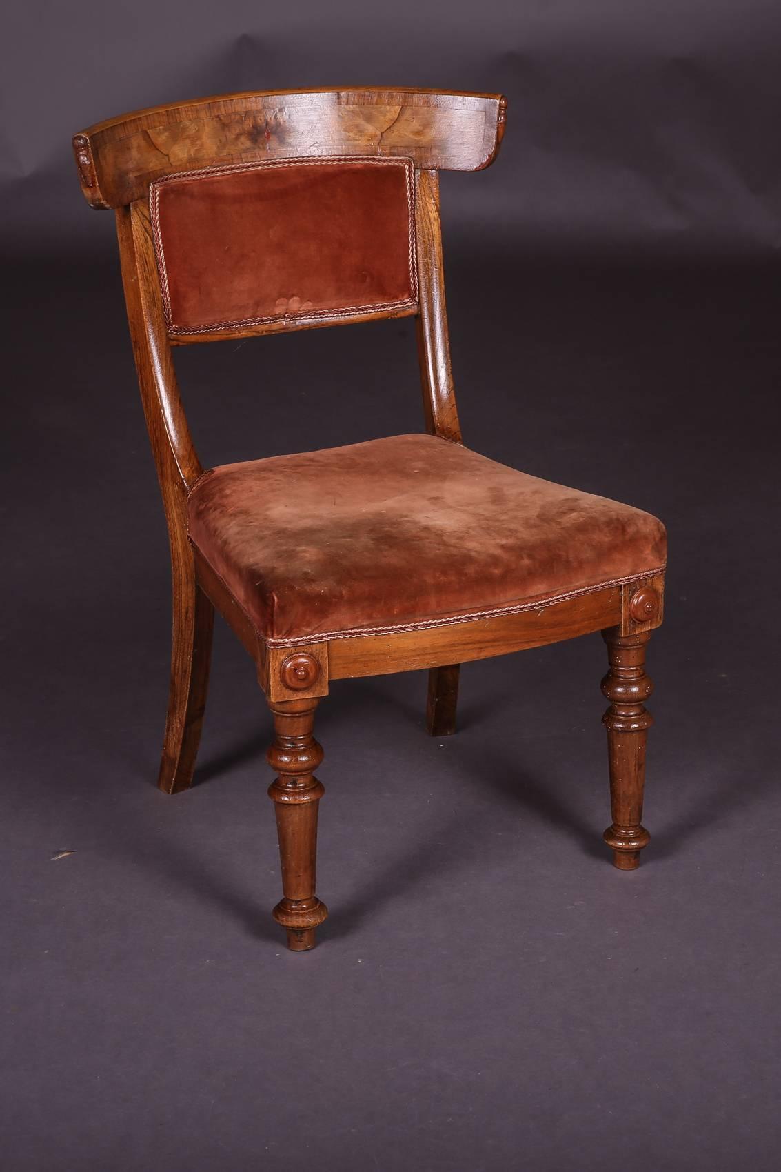 Biedermeier chair, circa 1845.
Solidwood with red cover. Rear legs saber-shaped. Wide curving backrest.

(C-127).