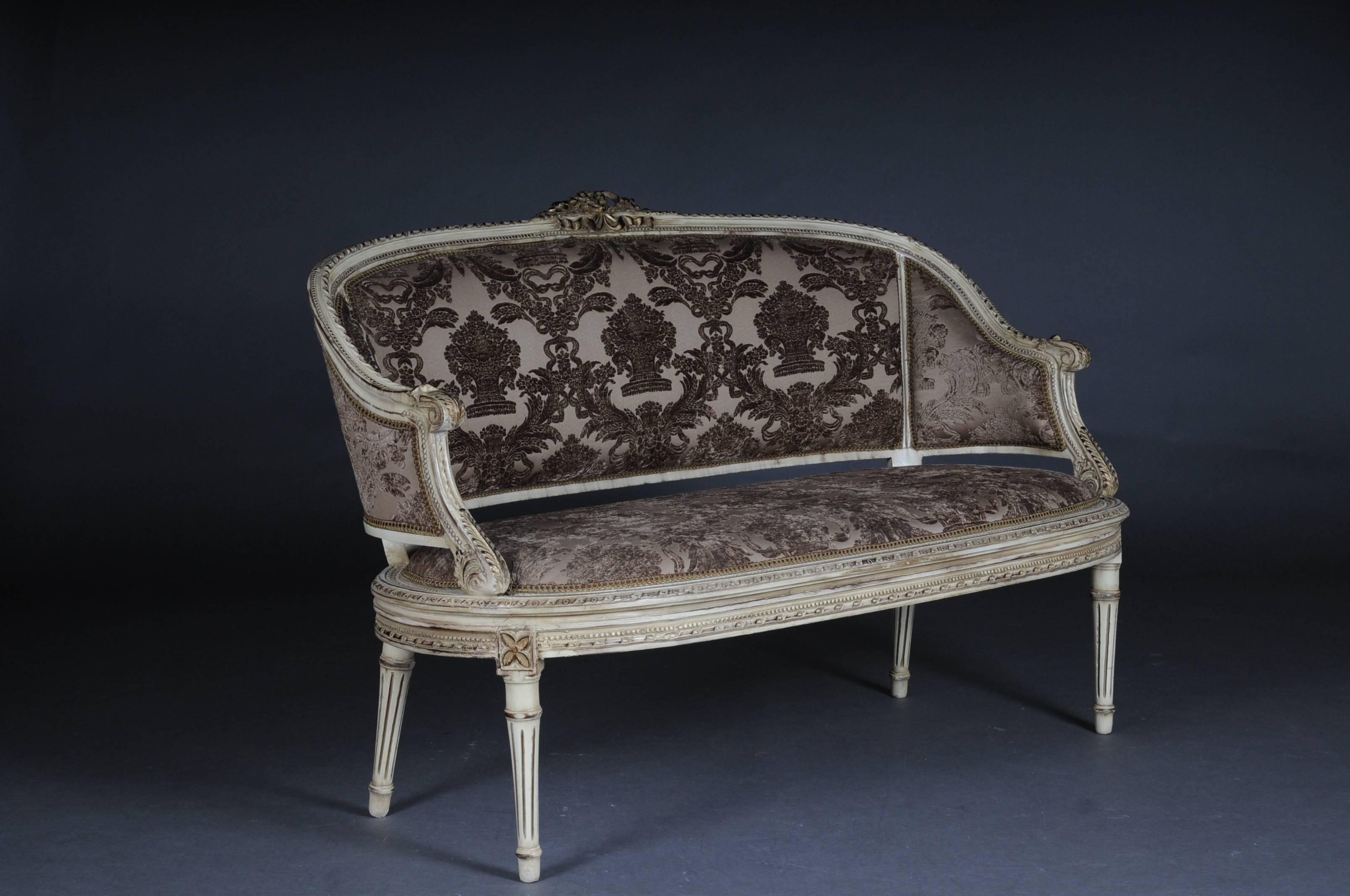 Solid beechwood, carved and partly gold-plated. Semicircular rising backrest framing with rocaille crowning. Profiled frame with richly decorated carving. Profiled frame on conical, fluted legs. Seat and backrest are finished with a historical,