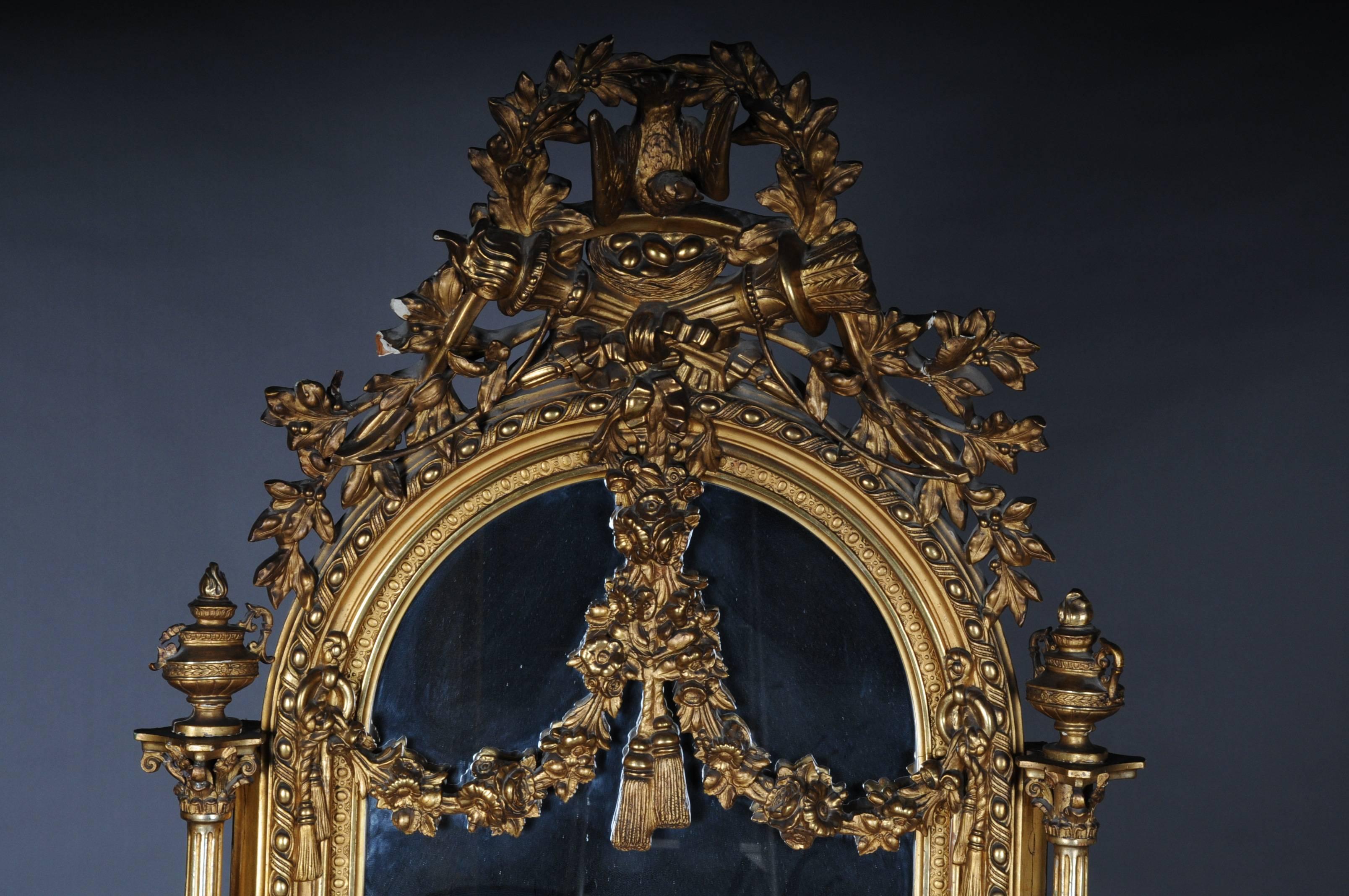 Spectacular mirror. Wood, carved, gilded. High frame with rounded graduation and garlands. As crowning plastic cock over nest and trophy. Side columns with plastically carved oil lamps, second half of the 19th century.


(M-36).